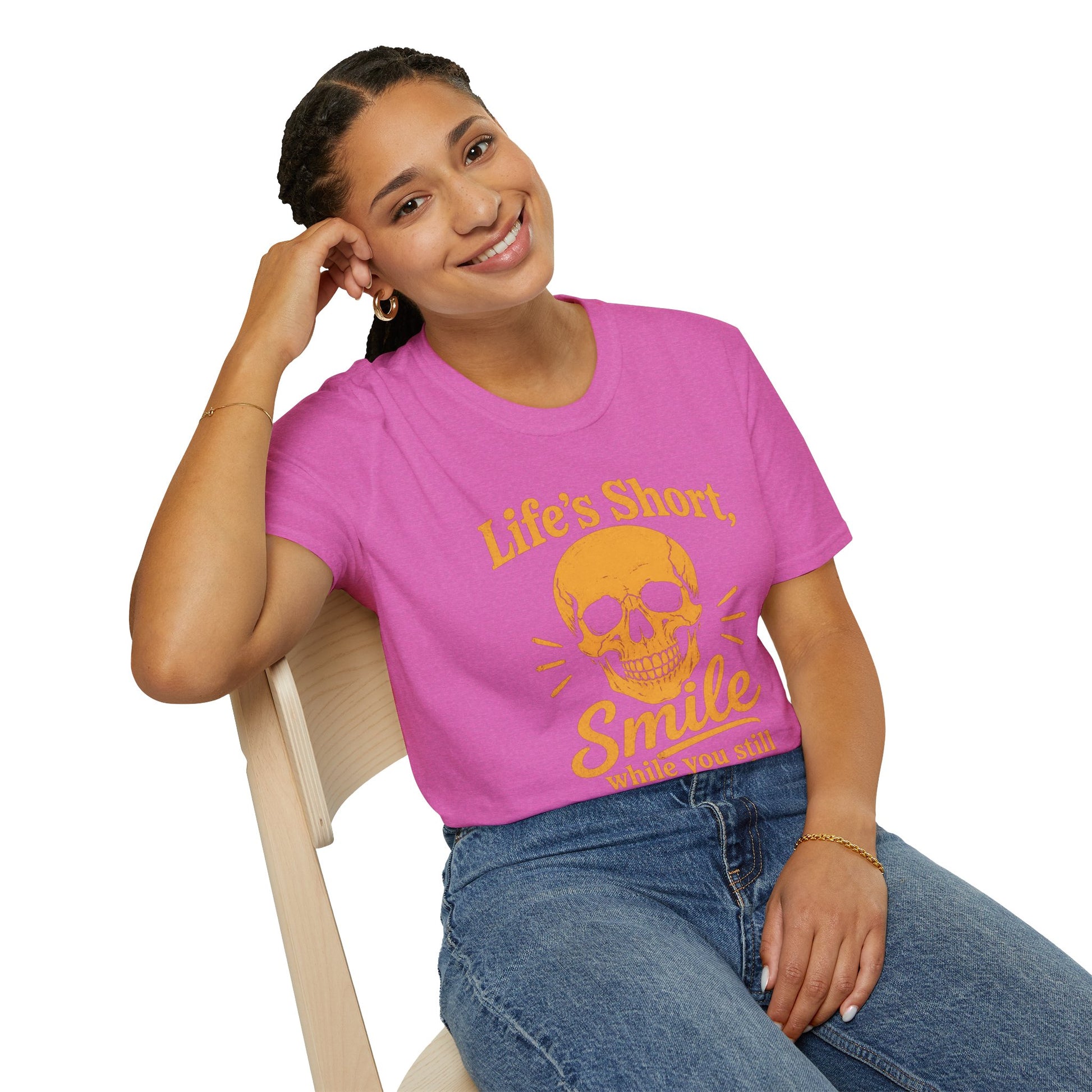 Life's Short, Smile While You Have Teeth Shirt, Heather Berry pink, worn by a model seated on a wooden chair