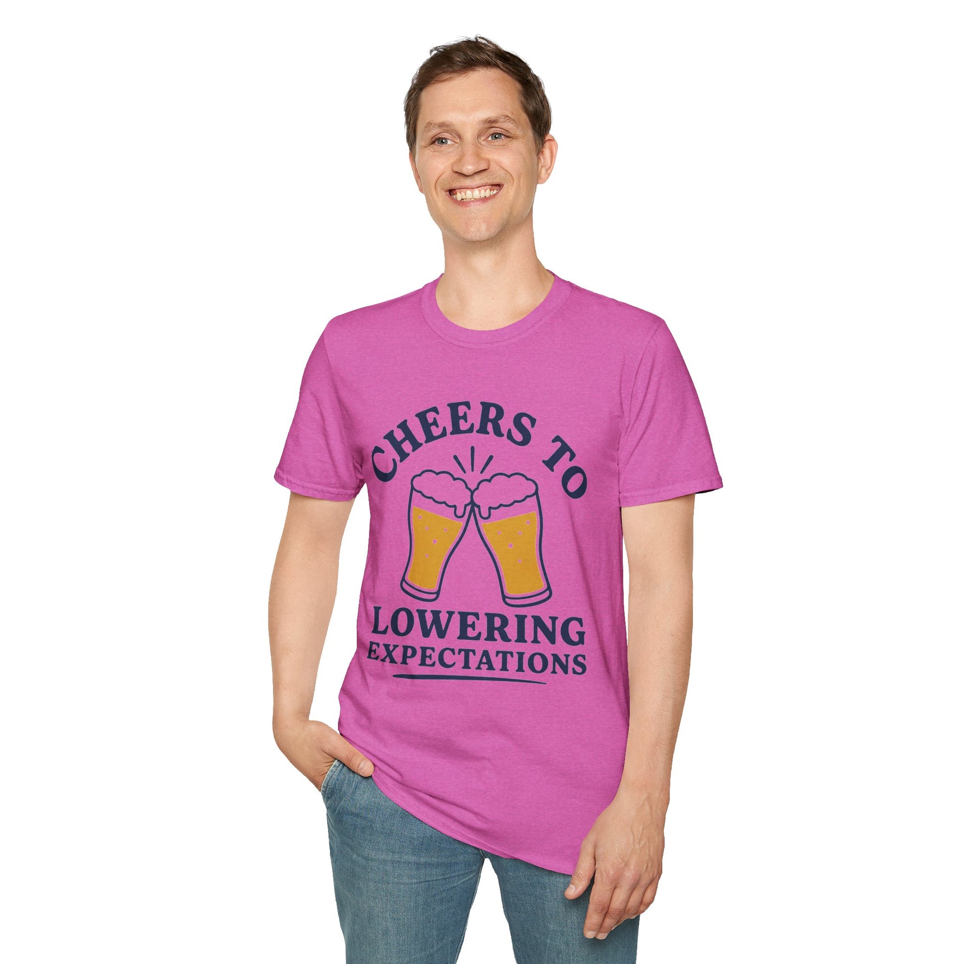 Cheers to Lowering Expectations Shirt, Heather Berry pink, worn by a standing model with one hand in their pocket