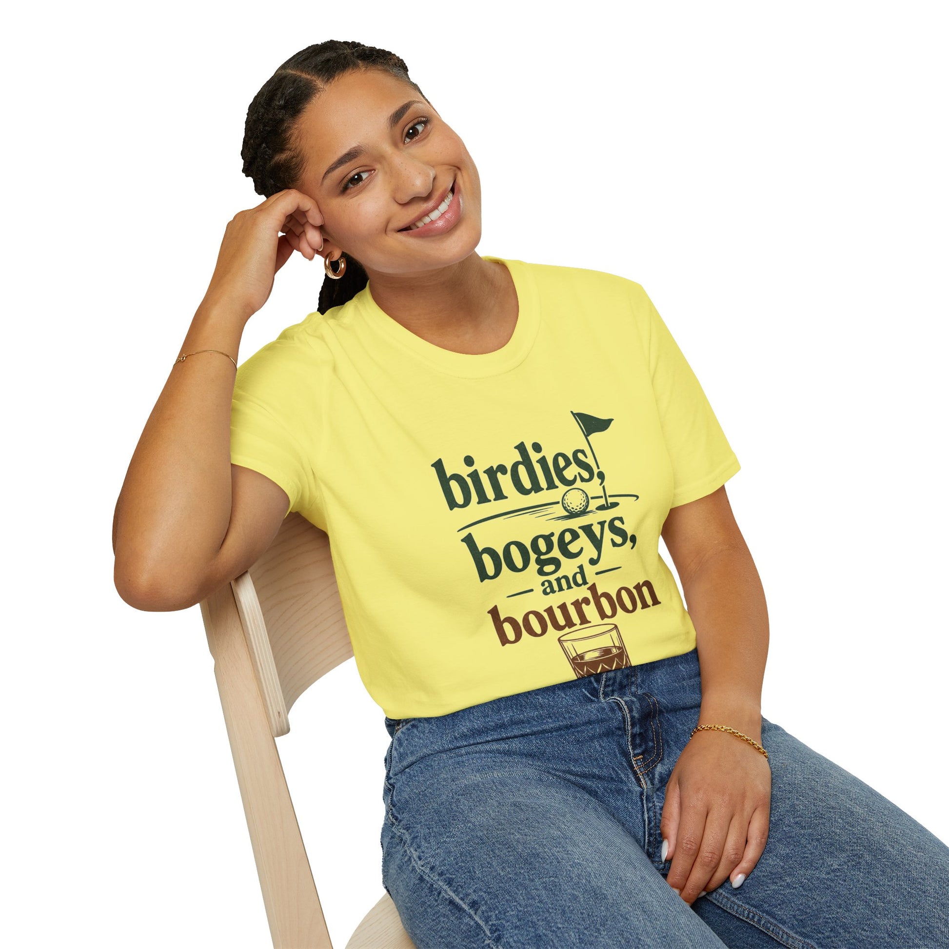 Birdies, Bogeys, and Bourbon Shirt, Cornsilk pale yellow, worn by a model seated on a wooden chair