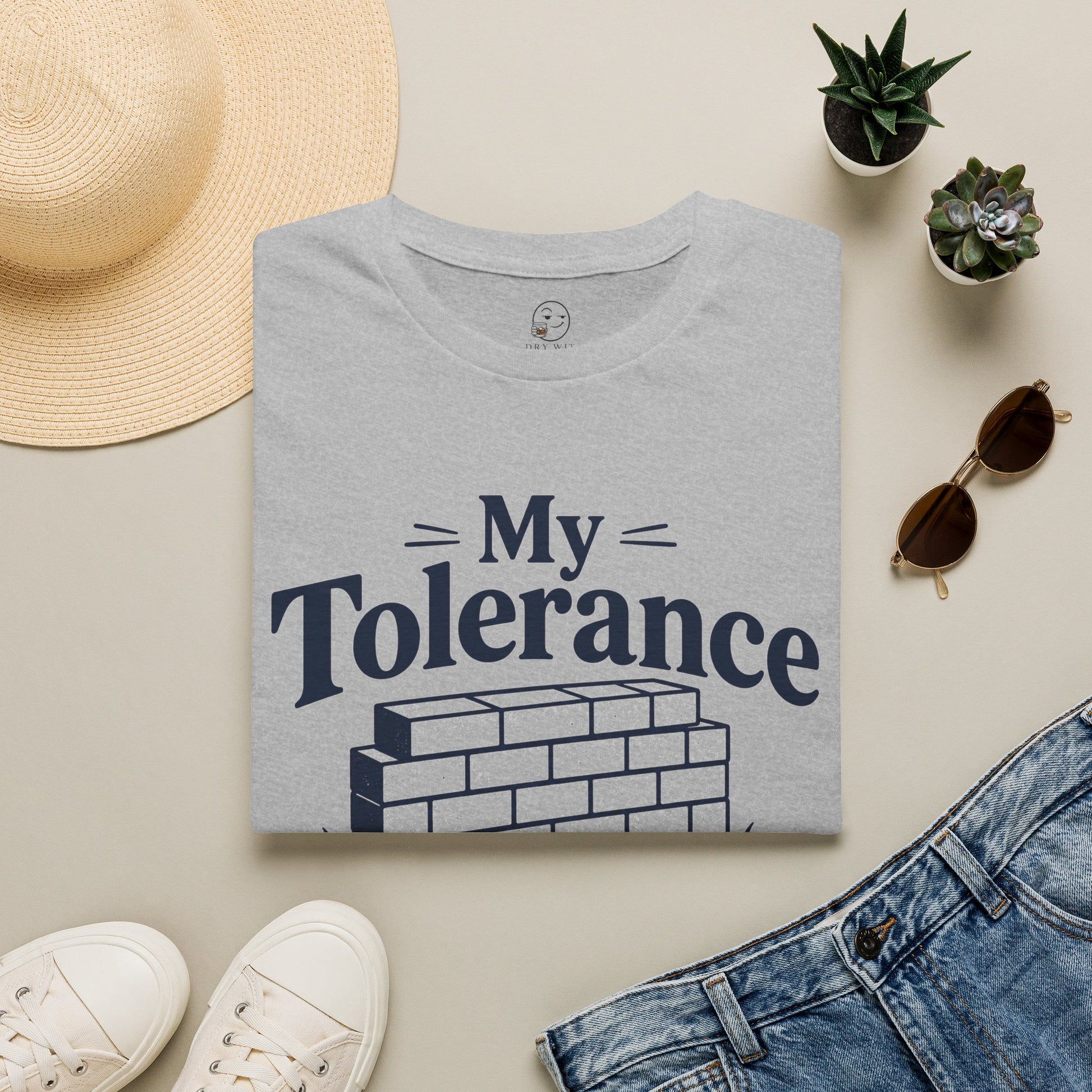 My Tolerance Is the Only Thing I've Built, Sport Grey, folded flat lay styled with a straw hat, sunglasses, sneakers and denim