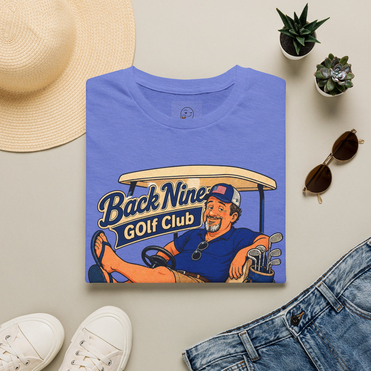 Back Nine Club Shirt, Heather Royal blue, folded flat lay styled with a straw hat, sunglasses, sneakers and denim