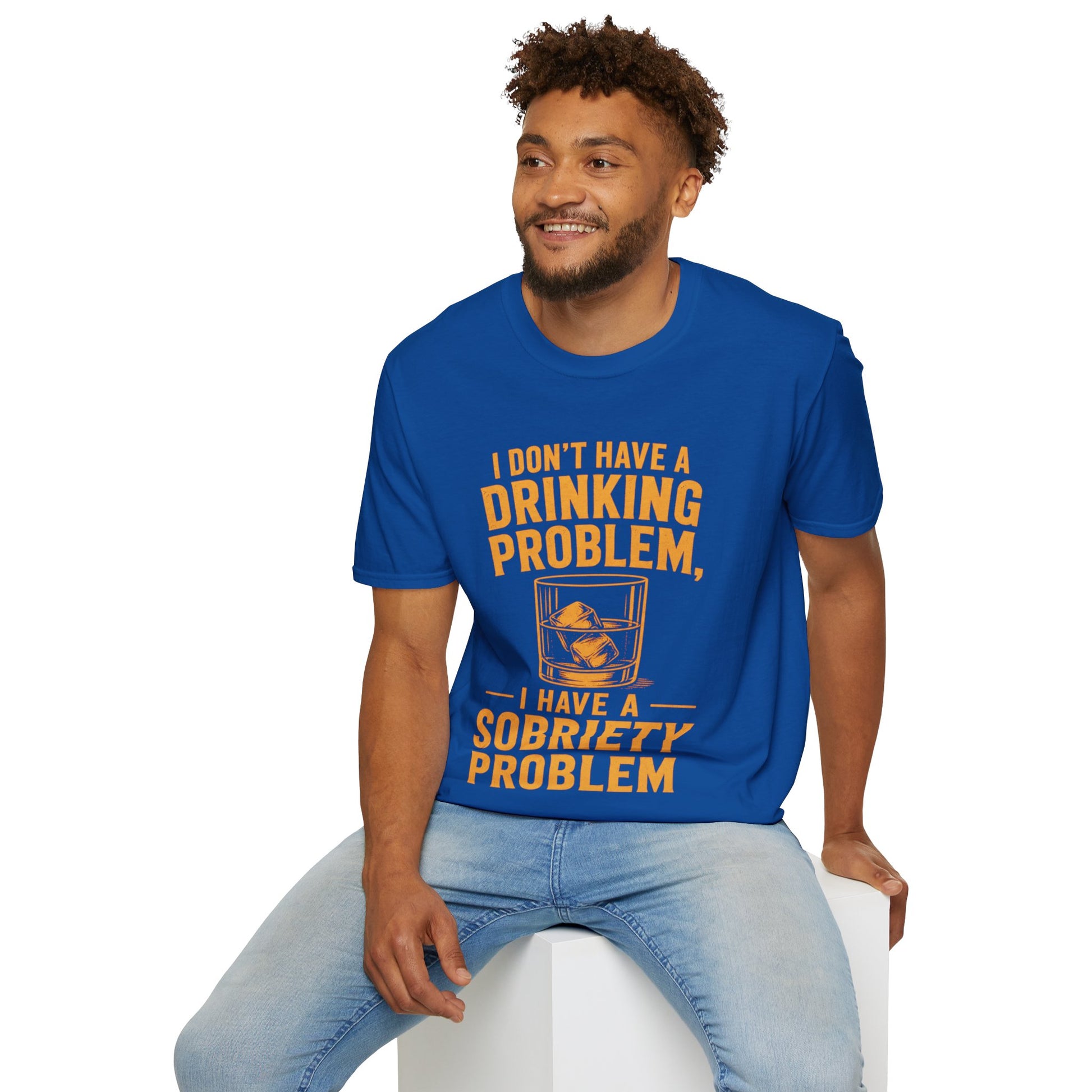 I Don't Have a Drinking Problem Shirt, Royal, worn by a model seated on a white block