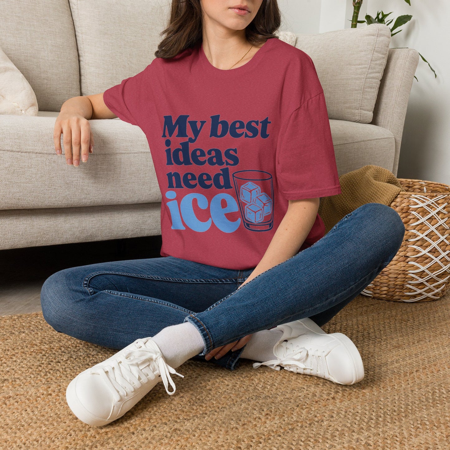 My Best Ideas Need Ice Shirt, Heather Cardinal red, worn by a model seated on the floor beside a sofa