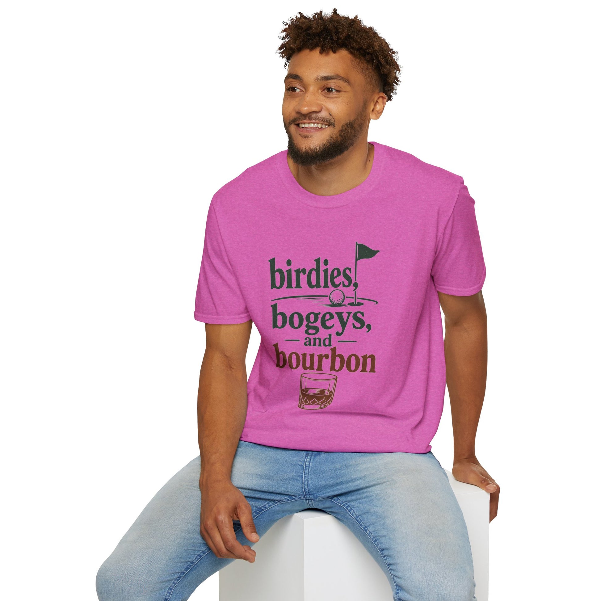 Birdies, Bogeys, and Bourbon Shirt, Heather Berry pink, worn by a model seated on a white block