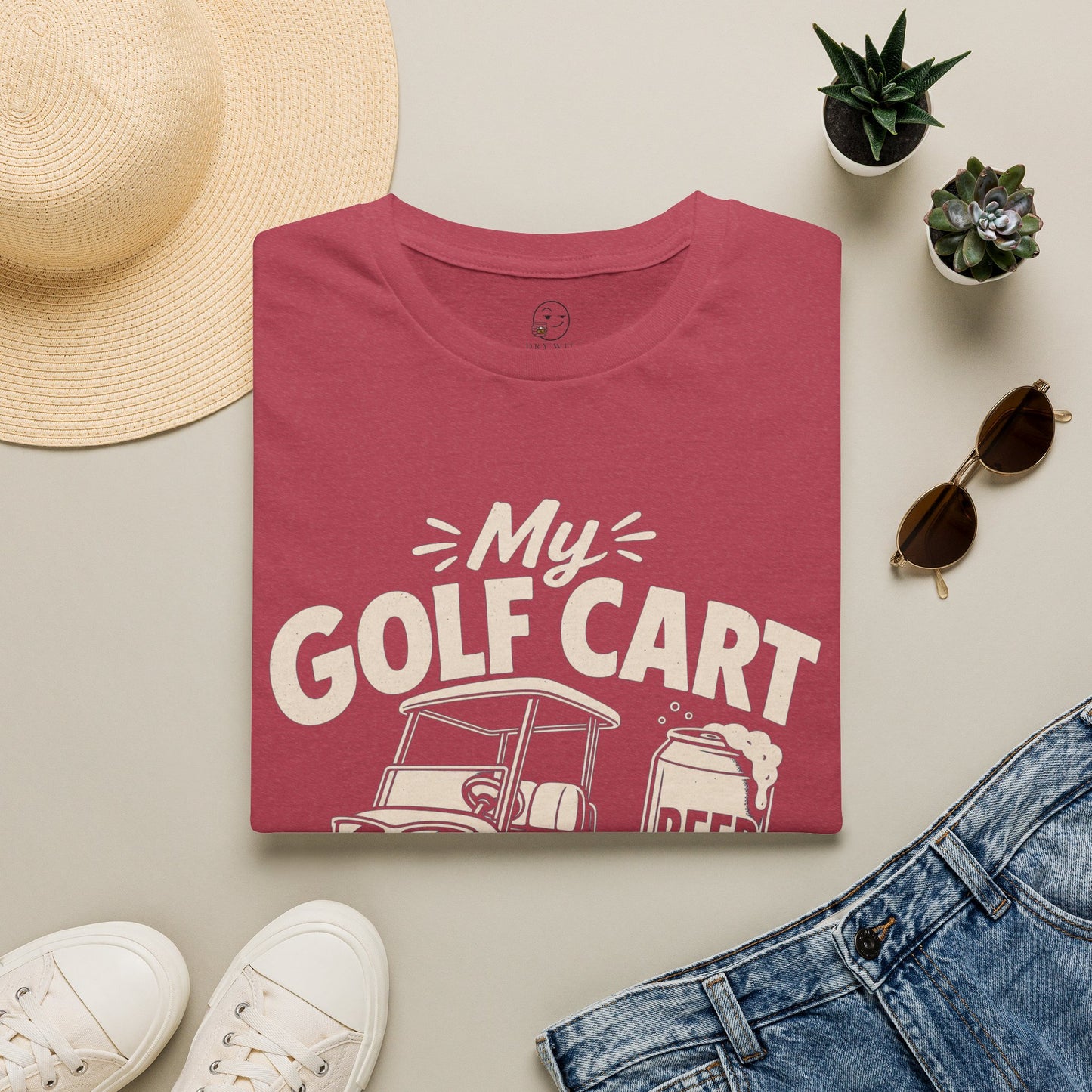 My Golf Cart Runs on Beer Shirt, Heather Cardinal red, folded flat lay styled with a straw hat, sunglasses, sneakers and denim