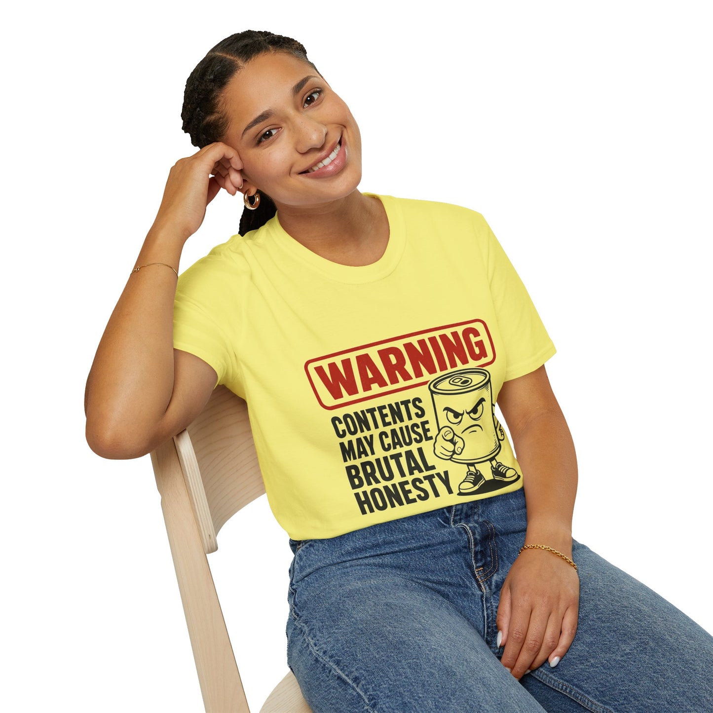 Warning: Contents May Cause Brutal Honesty Shirt, Cornsilk pale yellow, worn by a model seated on a wooden chair