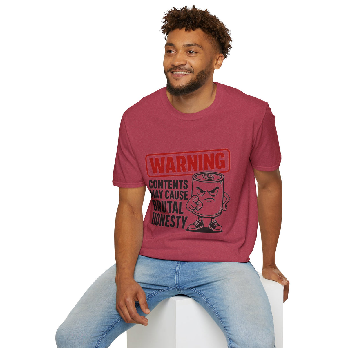 Warning: Contents May Cause Brutal Honesty Shirt, Heather Cardinal red, worn by a model seated on a white block