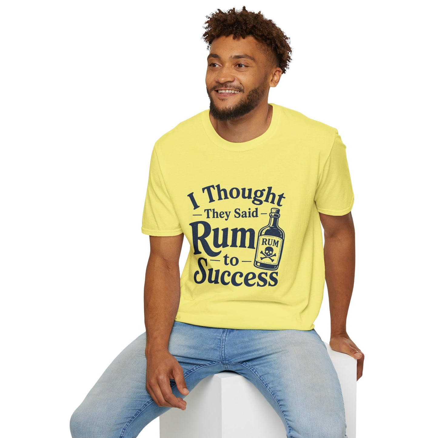 I Thought They Said Rum to Success Shirt, Cornsilk pale yellow, worn by a model seated on a white block