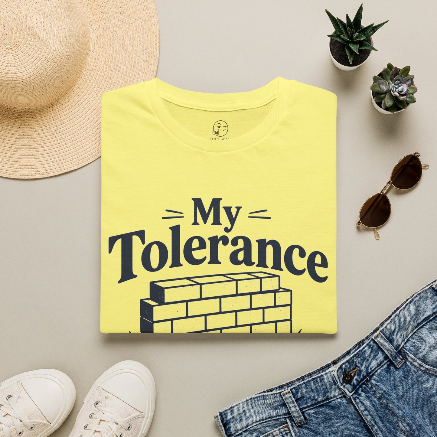 My Tolerance Is the Only Thing I've Built, Cornsilk pale yellow, folded flat lay styled with a straw hat, sunglasses, sneakers and denim