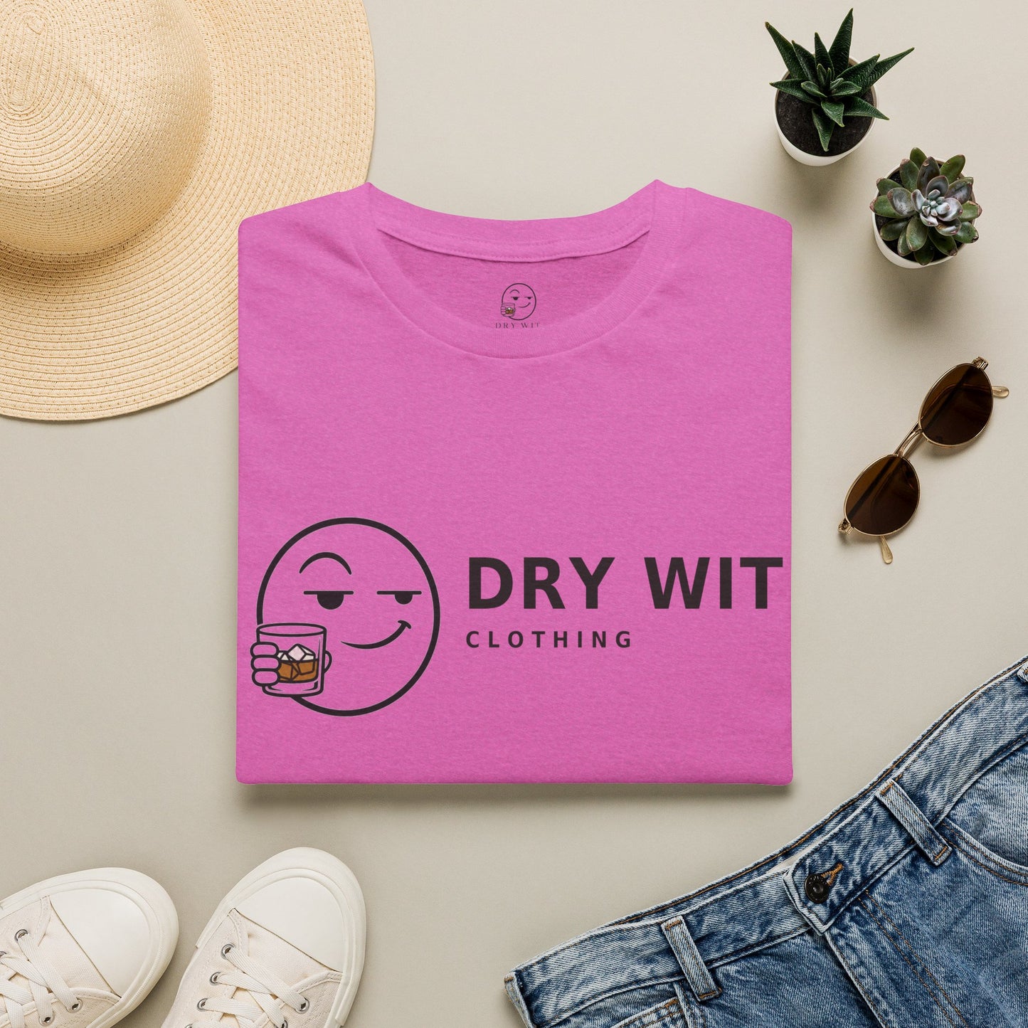 Dry Wit Logo Shirt, Heather Berry pink, folded flat lay styled with a straw hat, sunglasses, sneakers and denim