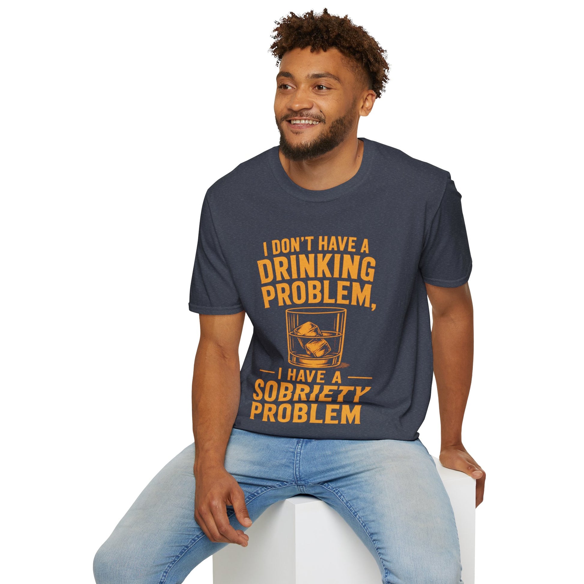 I Don't Have a Drinking Problem Shirt, Heather Navy, worn by a model seated on a white block