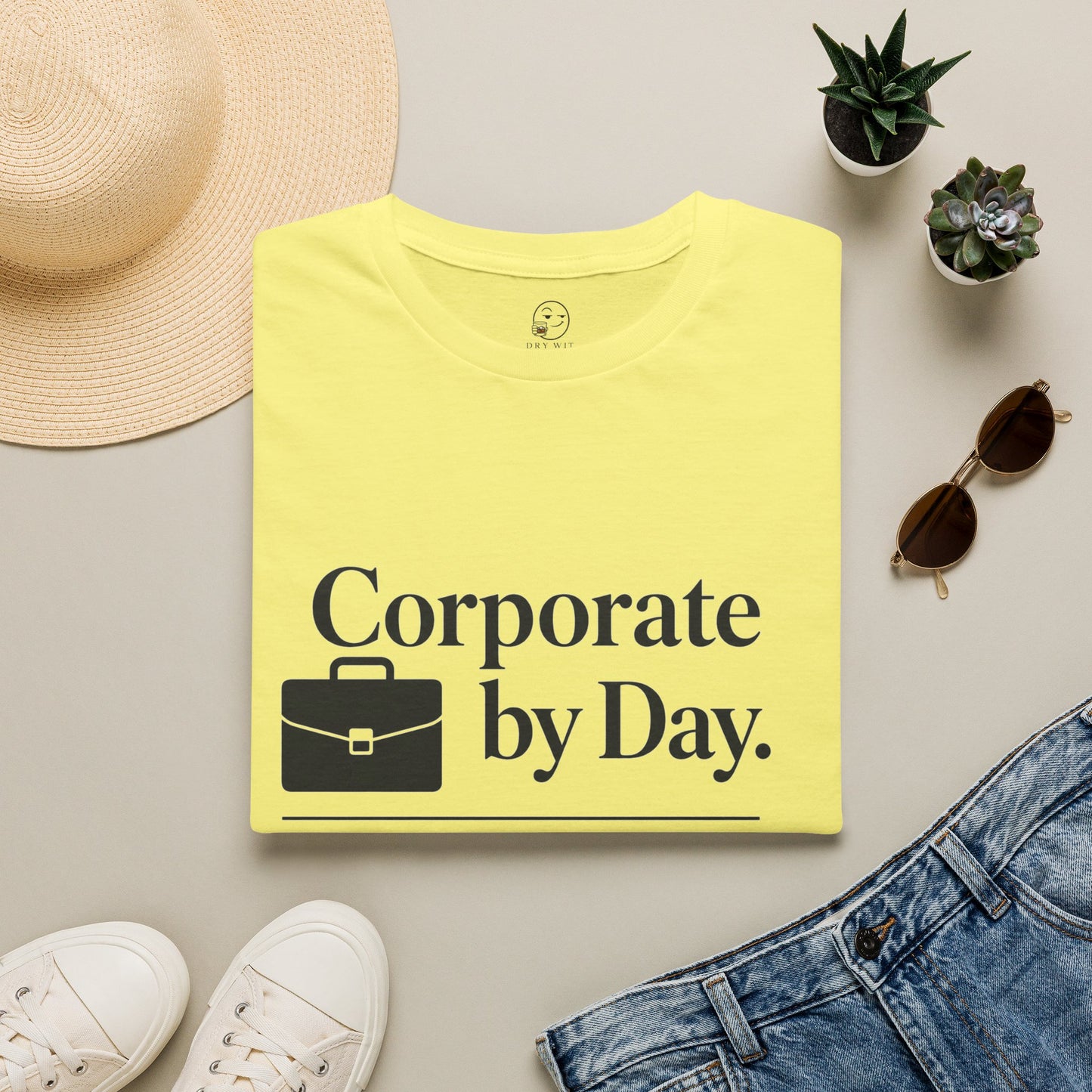 Corporate by Day, Cocktails by Night Shirt, Cornsilk pale yellow, folded flat lay styled with a straw hat, sunglasses, sneakers and denim