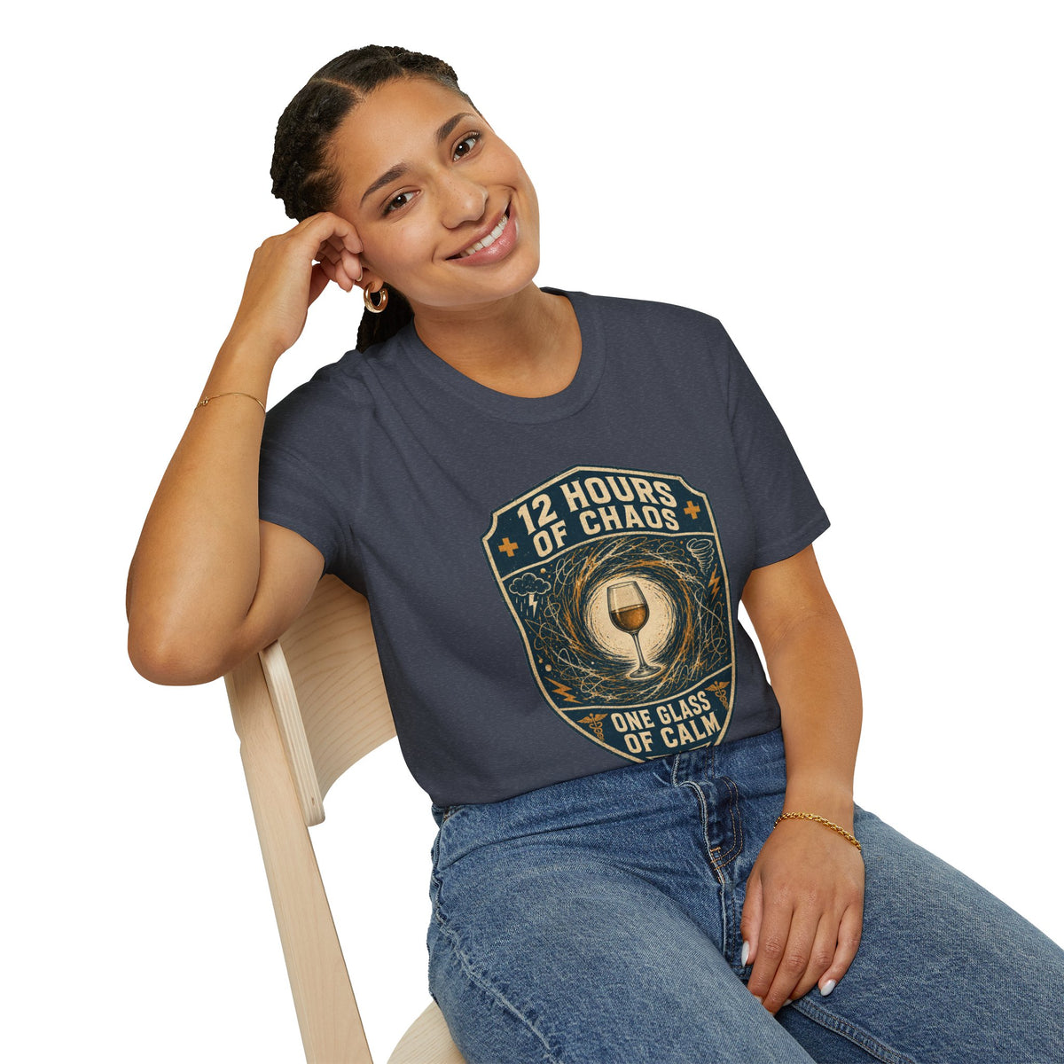 12 Hours of Chaos Shirt, Heather Navy, worn by a model seated on a wooden chair