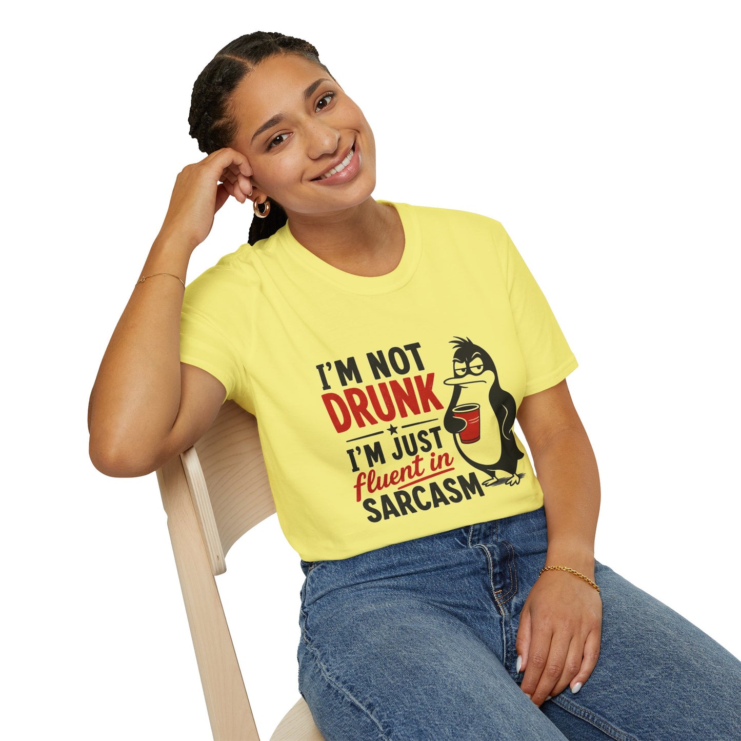 I'm Not Drunk, I'm Just Fluent in Sarcasm Shirt, Cornsilk pale yellow, worn by a model seated on a wooden chair