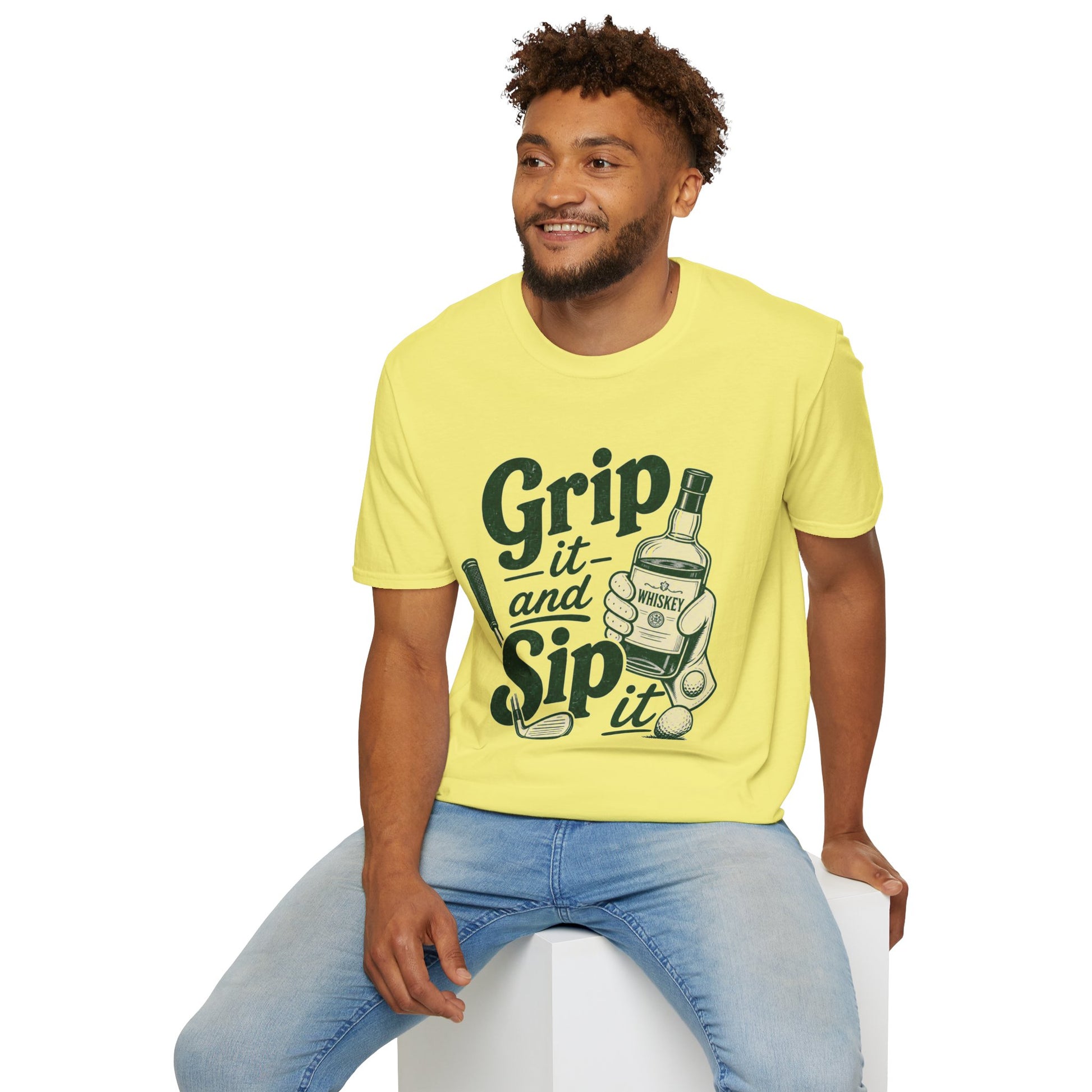 Grip It and Sip It funny golf whiskey shirt, Cornsilk pale yellow, worn by a seated model