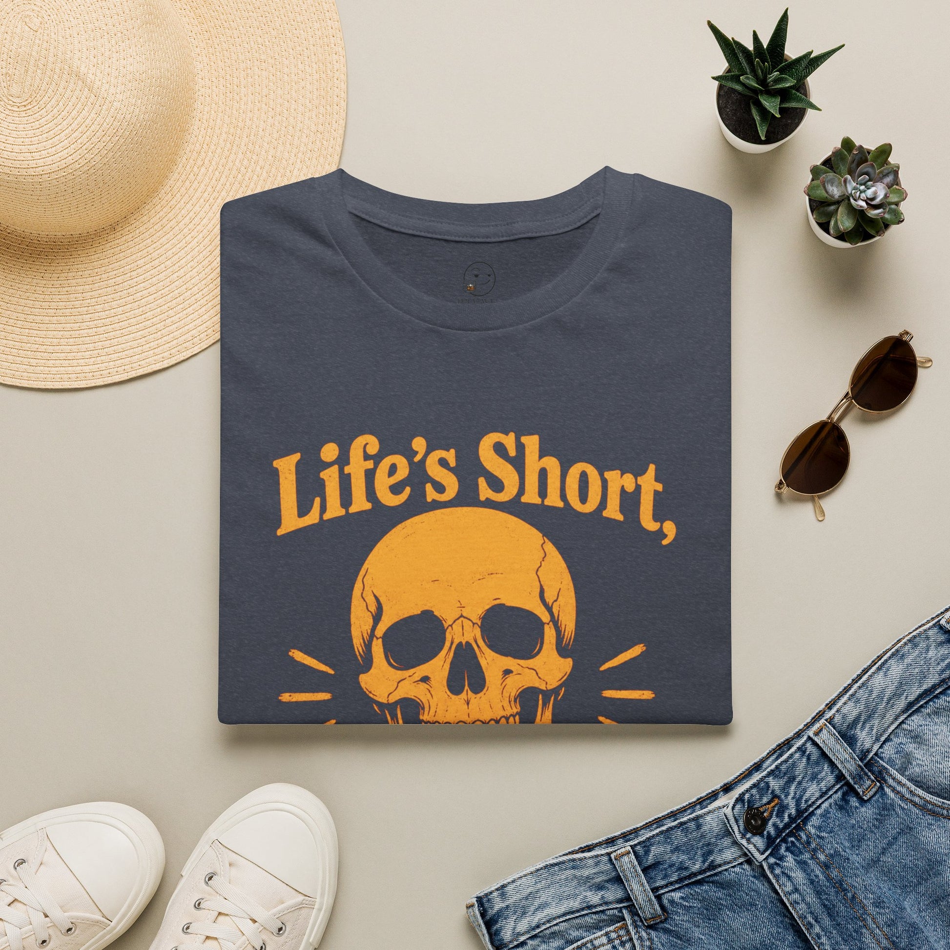 Life's Short, Smile While You Have Teeth Shirt, Heather Navy, folded flat lay styled with a straw hat, sunglasses, sneakers and denim