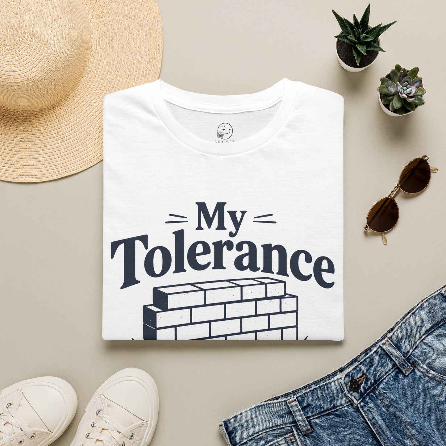 My Tolerance Is the Only Thing I've Built, White, folded flat lay styled with a straw hat, sunglasses, sneakers and denim