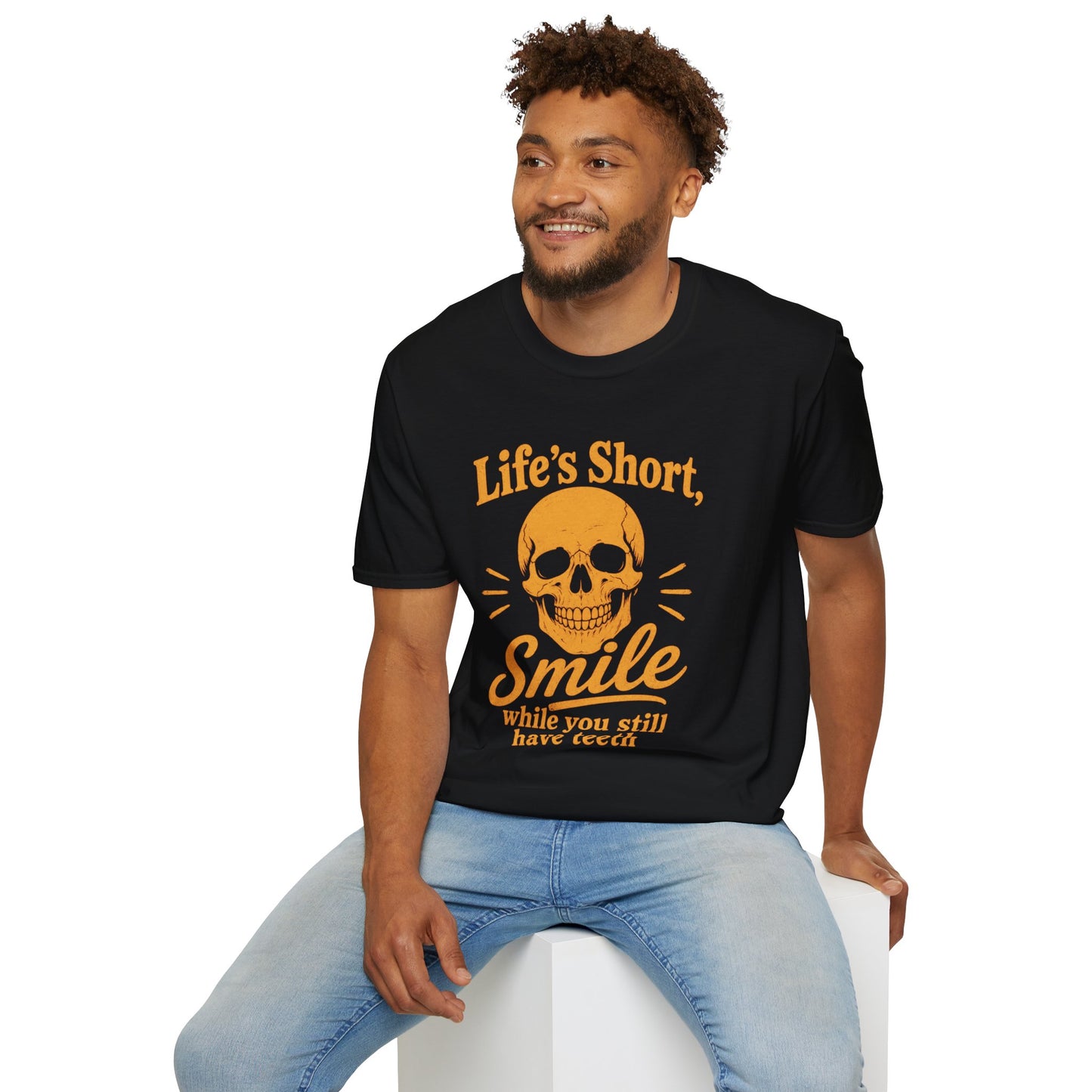 Life's Short, Smile While You Have Teeth Shirt, Black, worn by a model seated on a white block