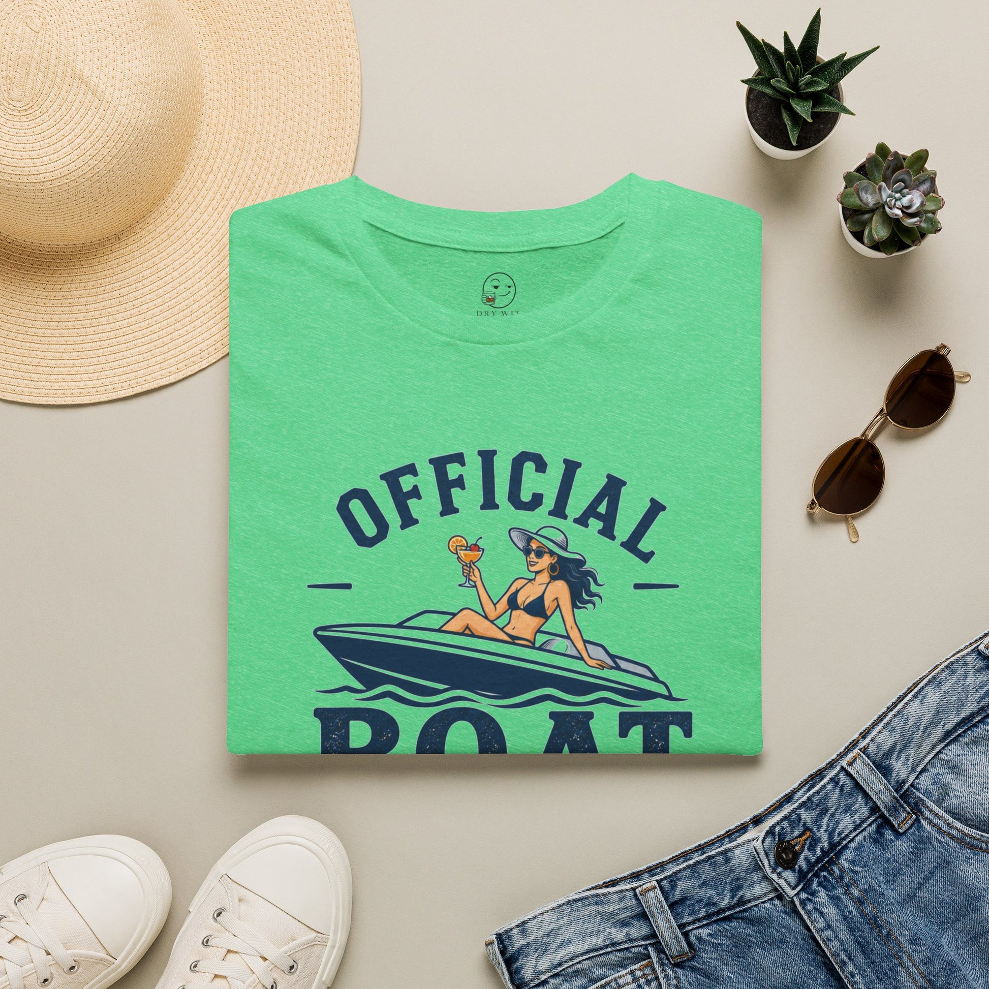 Official Boat Cocktail Drink Tester Shirt, Heather Irish Green mint, folded flat lay styled with a straw hat, sunglasses, sneakers and denim