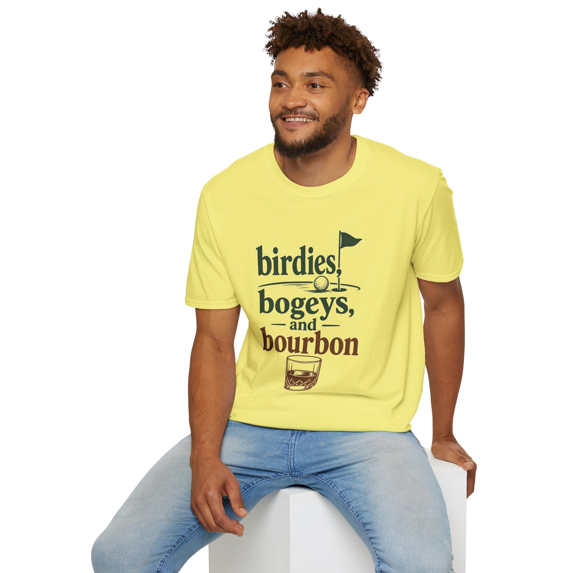 Birdies, Bogeys, and Bourbon Shirt, Cornsilk pale yellow, worn by a model seated on a white block