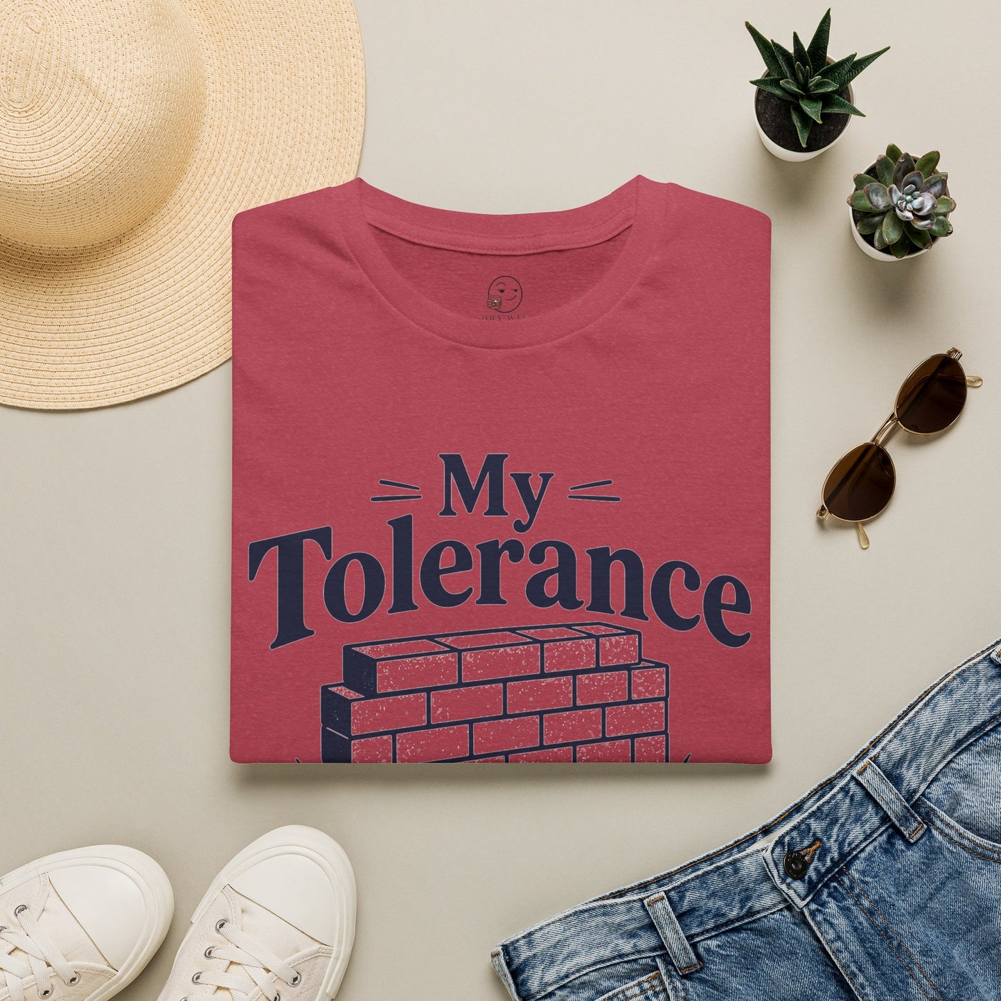 My Tolerance Is the Only Thing I've Built, Heather Cardinal red, folded flat lay styled with a straw hat, sunglasses, sneakers and denim
