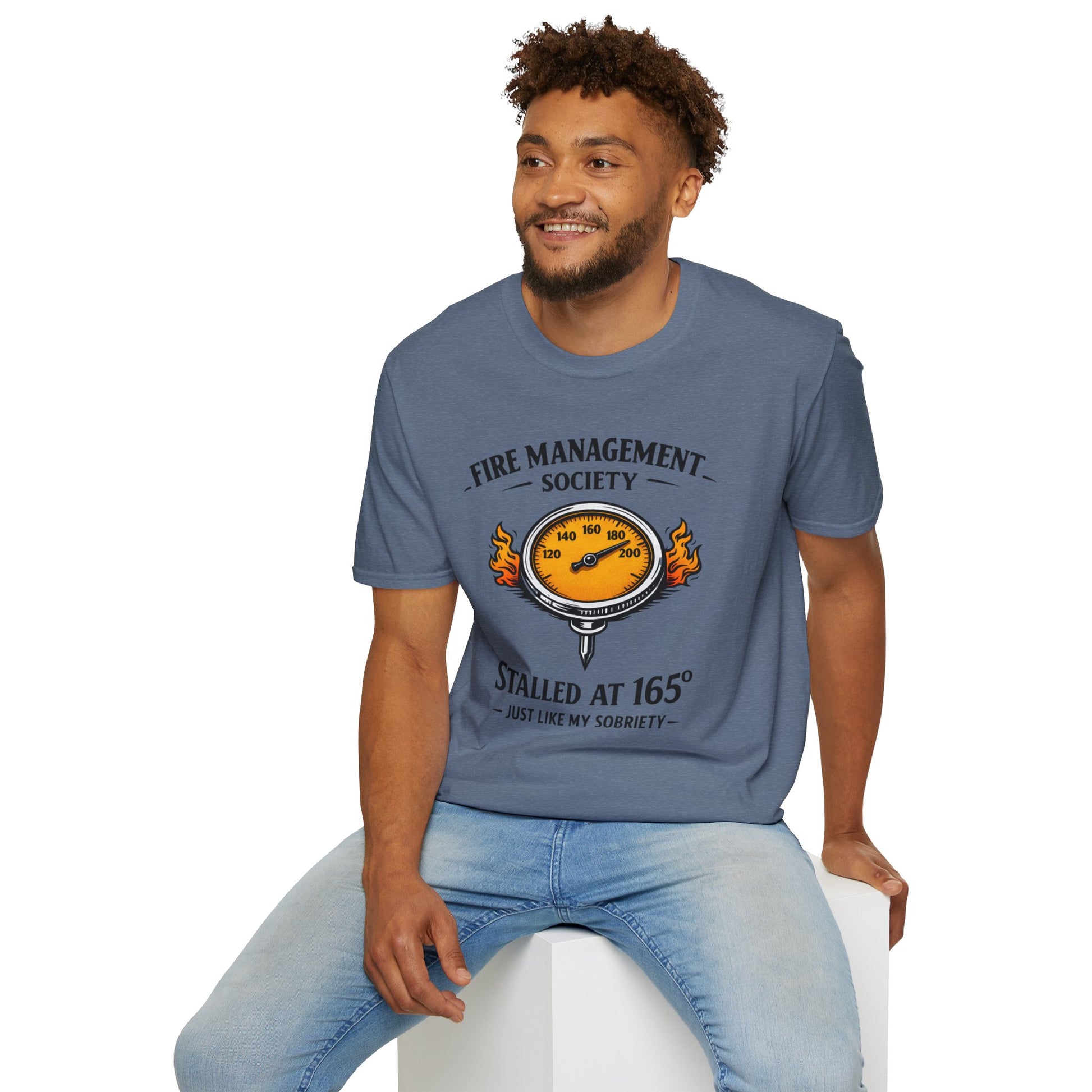 Fire Management Society Shirt, Heather Indigo slate blue, worn by a model seated on a white block