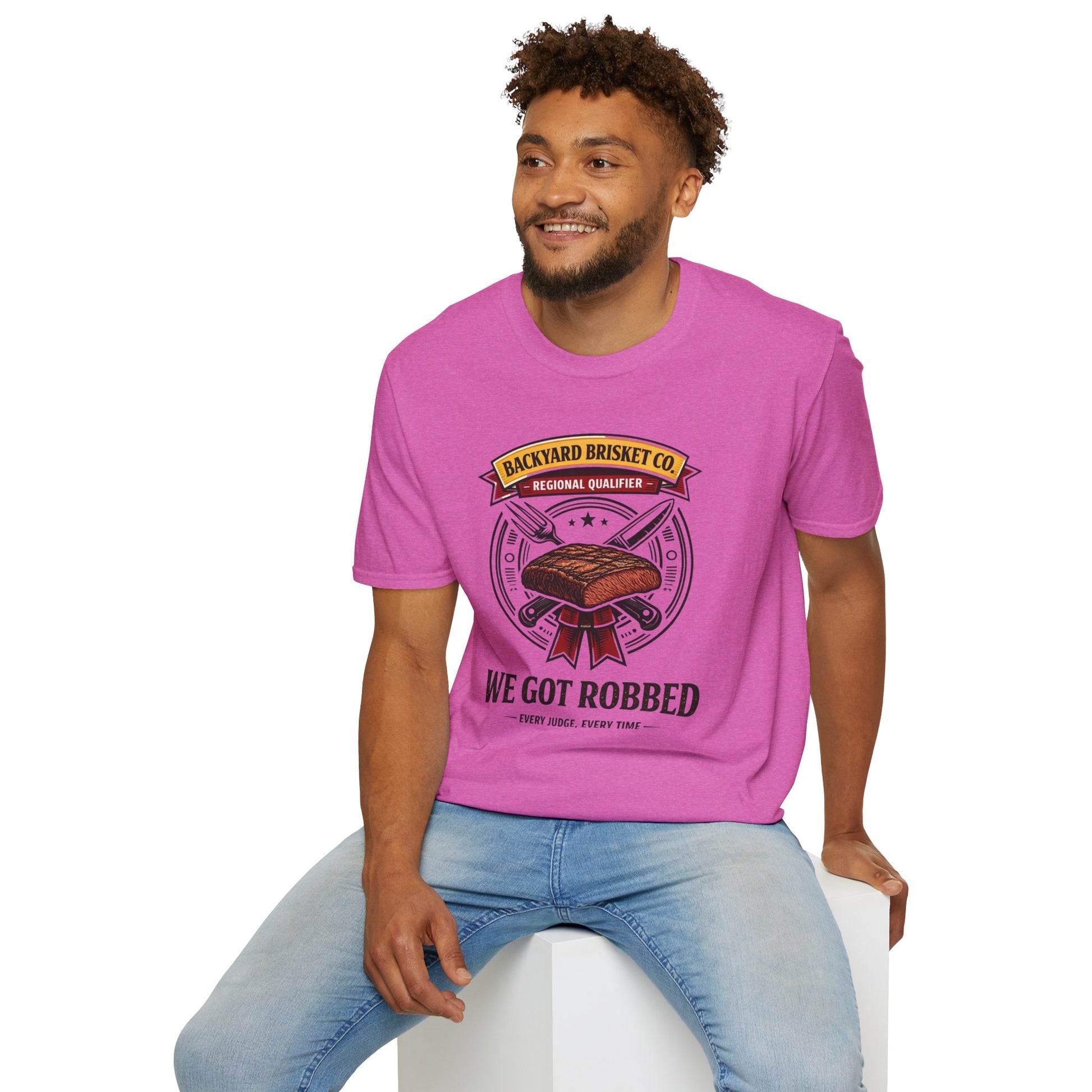 Backyard Brisket Co. Shirt, Heather Berry pink, worn by a model seated on a white block