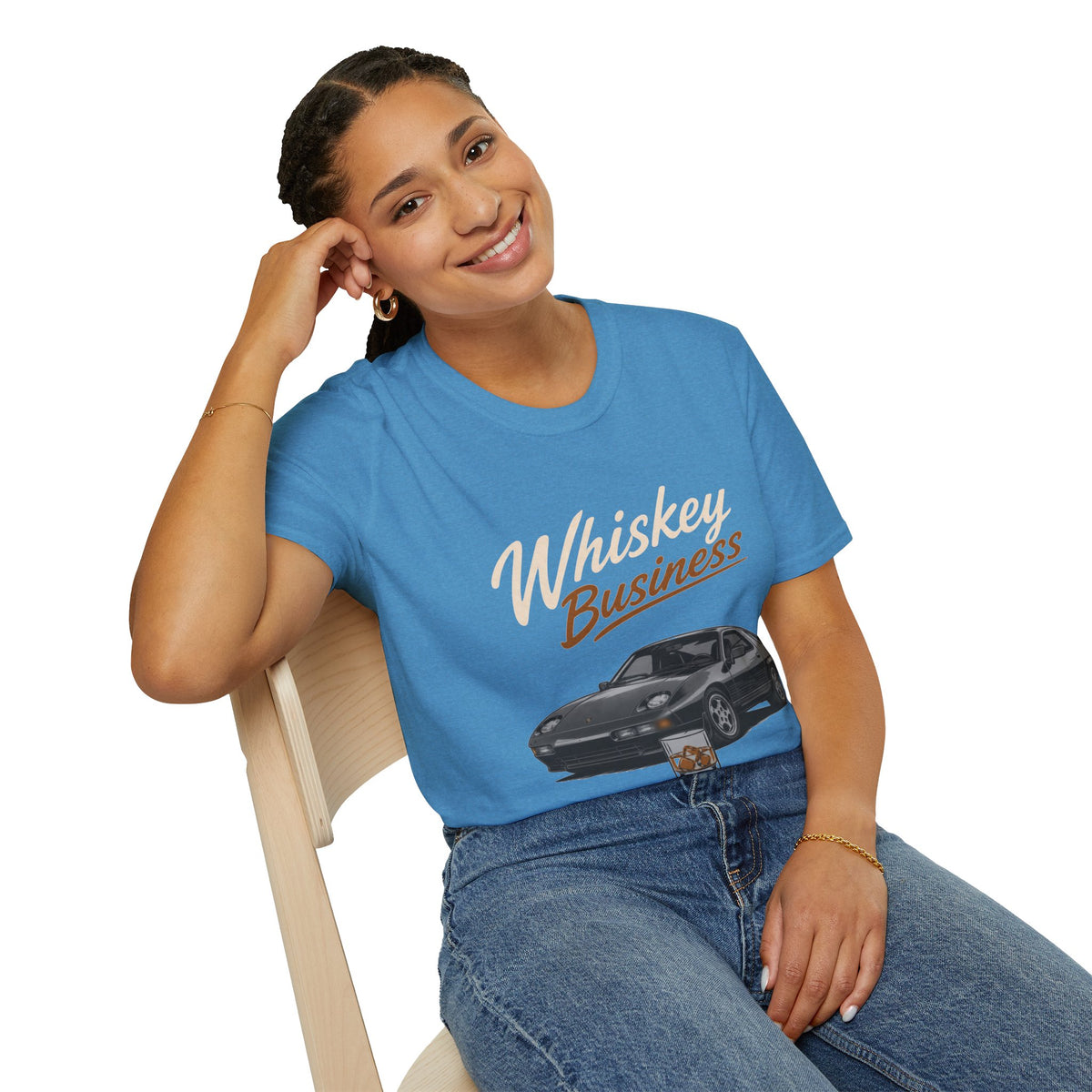 Whiskey Business Shirt, Heather Sapphire blue, worn by a model seated on a wooden chair