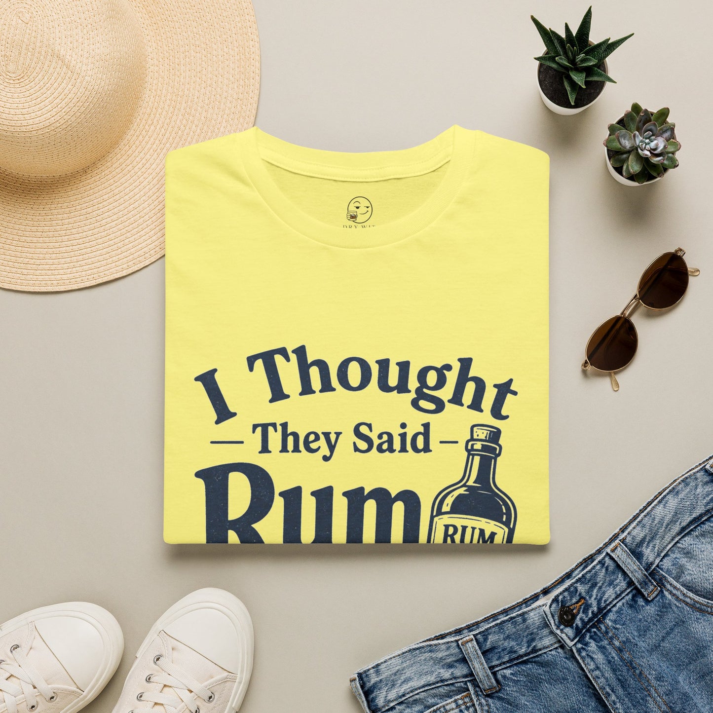 I Thought They Said Rum to Success Shirt, Cornsilk pale yellow, folded flat lay styled with a straw hat, sunglasses, sneakers and denim