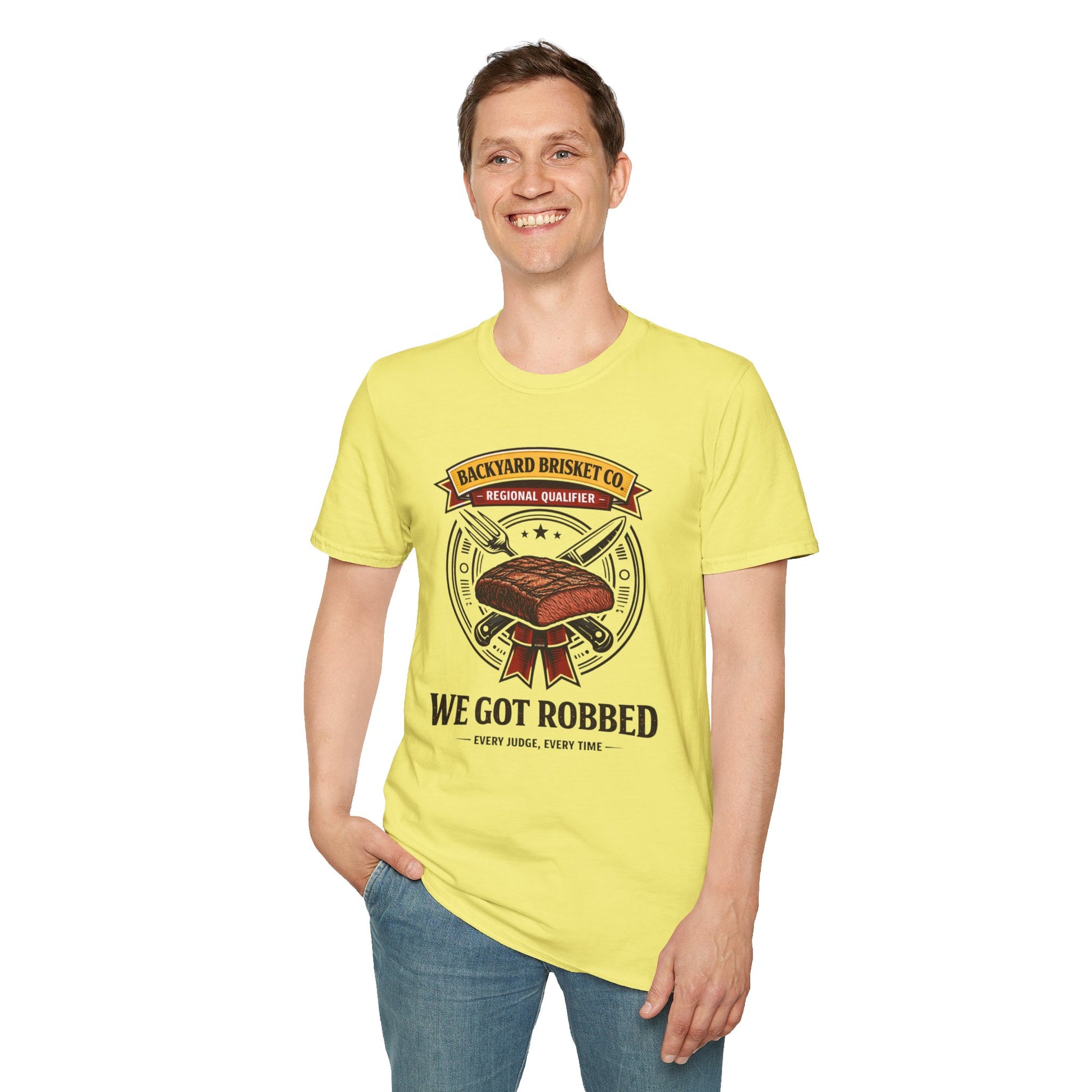 Backyard Brisket Co. Shirt, Cornsilk pale yellow, worn by a standing model with one hand in their pocket