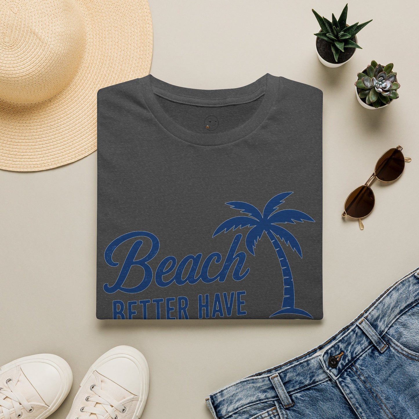 Beach Better Have My Cocktail Shirt, Dark Heather charcoal, folded flat lay styled with a straw hat, sunglasses, sneakers and denim