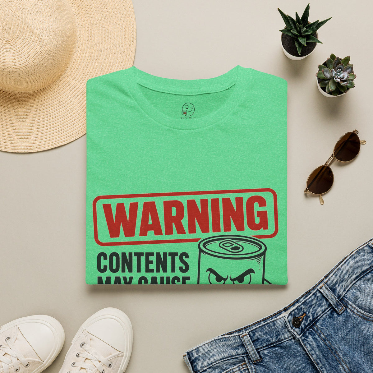 Warning: Contents May Cause Brutal Honesty Shirt, Heather Irish Green mint, folded flat lay styled with a straw hat, sunglasses, sneakers and denim