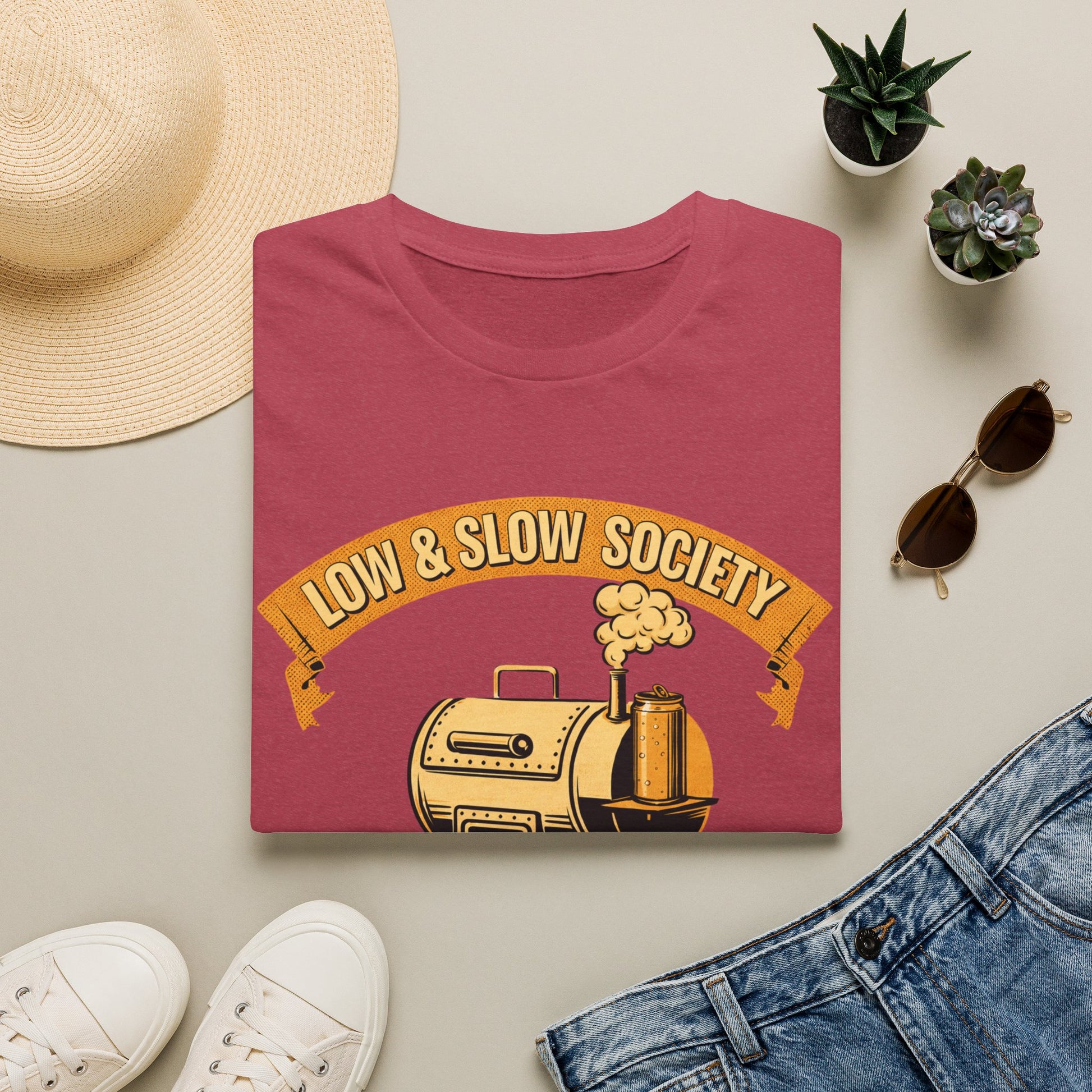Low & Slow Society Shirt, Heather Cardinal red, folded flat lay styled with a straw hat, sunglasses, sneakers and denim