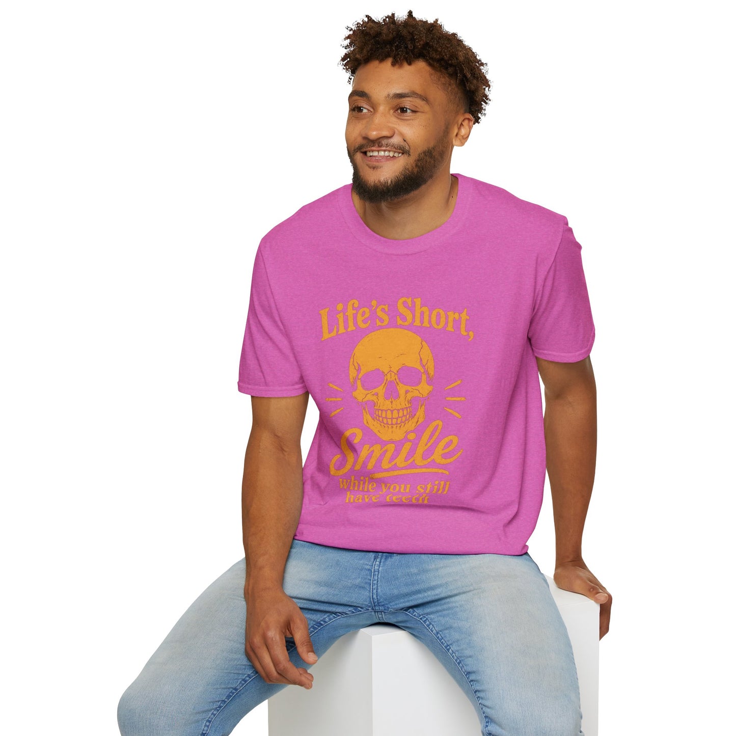 Life's Short, Smile While You Have Teeth Shirt, Heather Berry pink, worn by a model seated on a white block