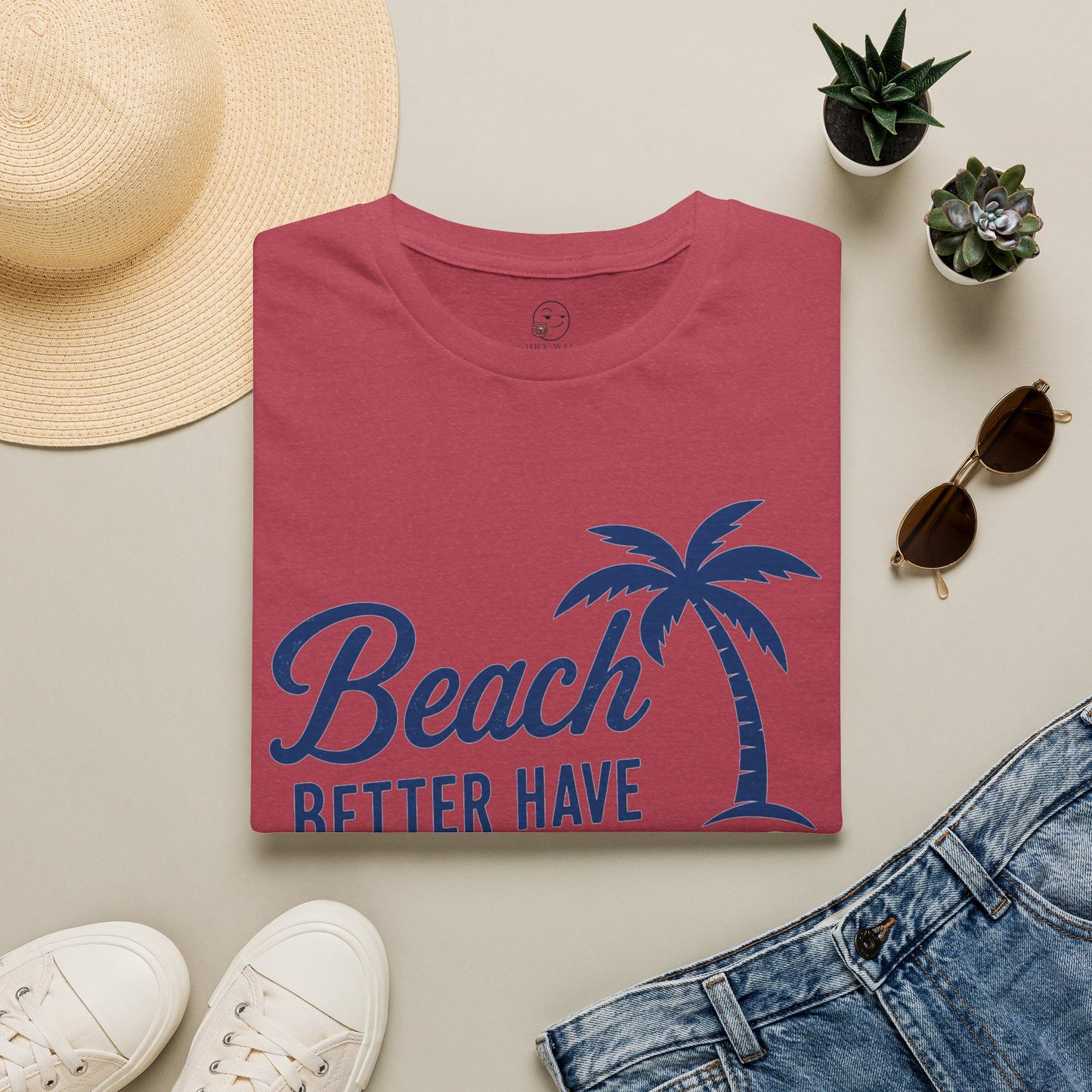 Beach Better Have My Cocktail Shirt, Heather Cardinal red, folded flat lay styled with a straw hat, sunglasses, sneakers and denim