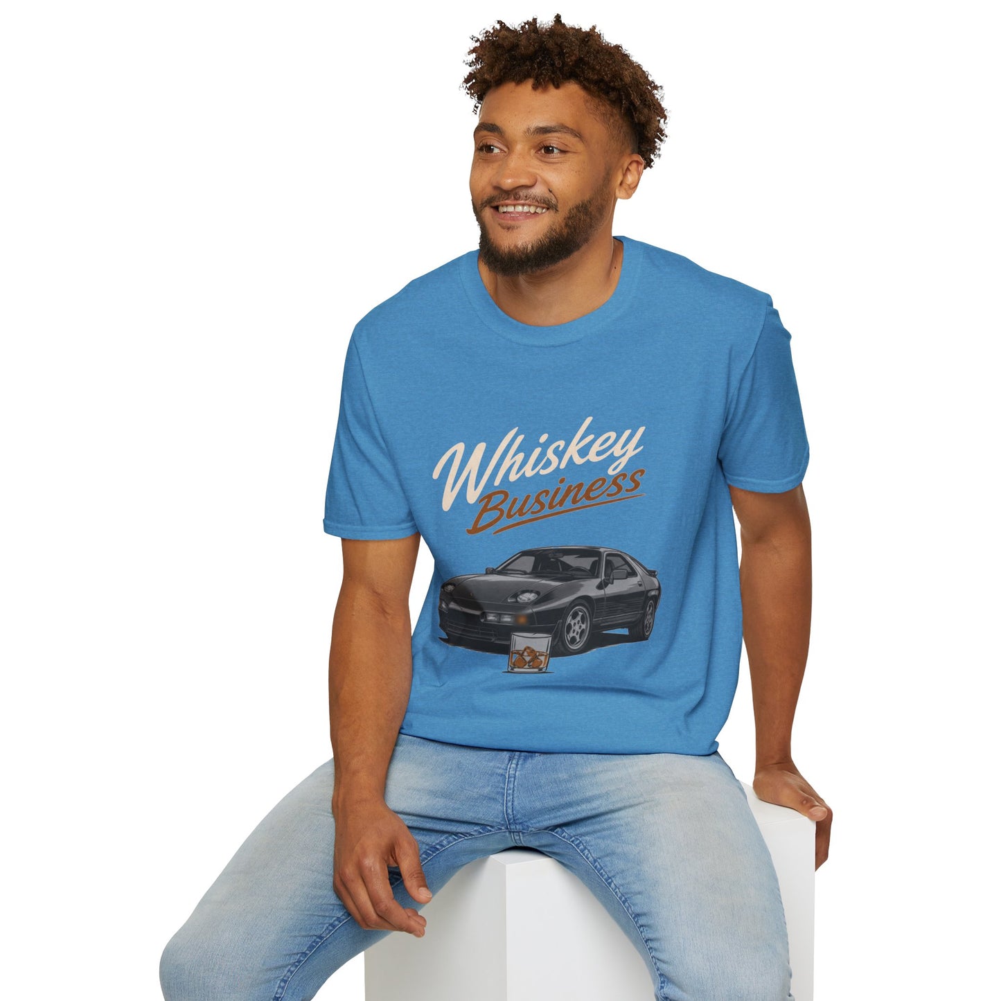 Whiskey Business Shirt, Heather Sapphire blue, worn by a model seated on a white block
