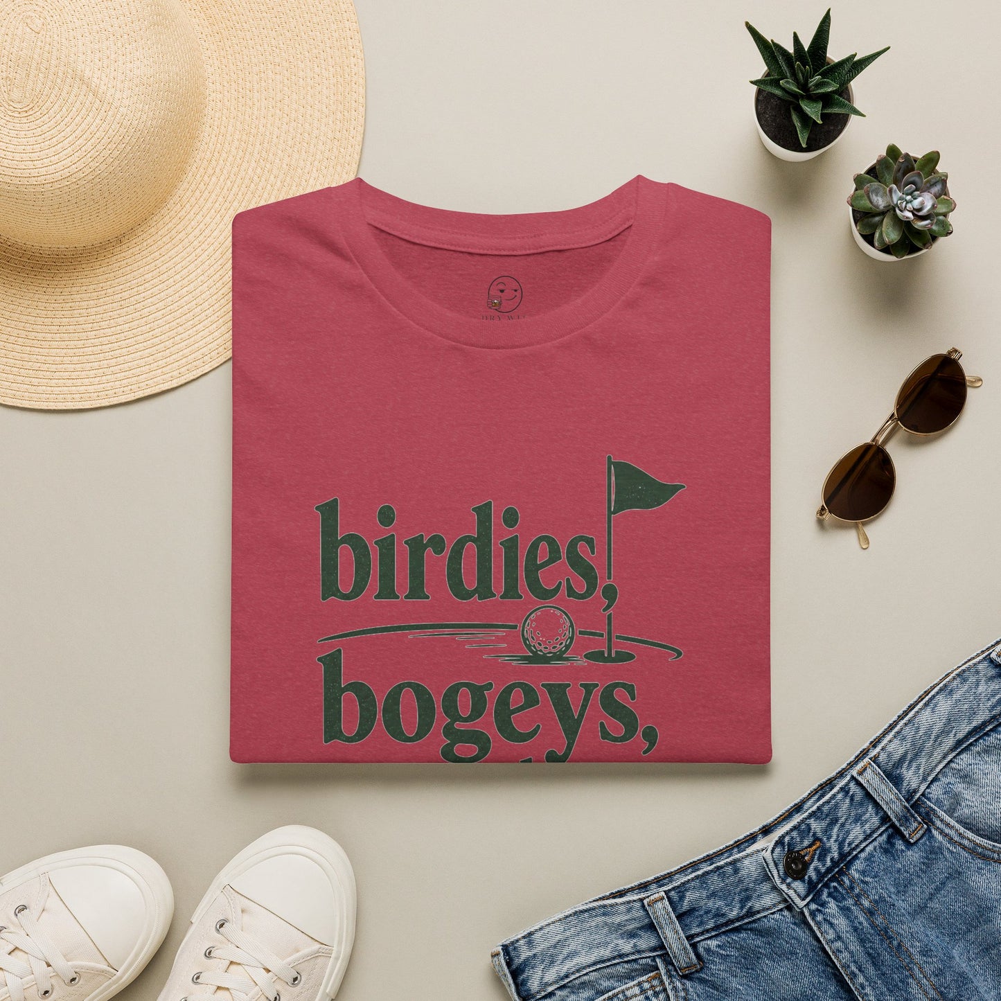 Birdies, Bogeys, and Bourbon Shirt, Heather Cardinal red, folded flat lay styled with a straw hat, sunglasses, sneakers and denim