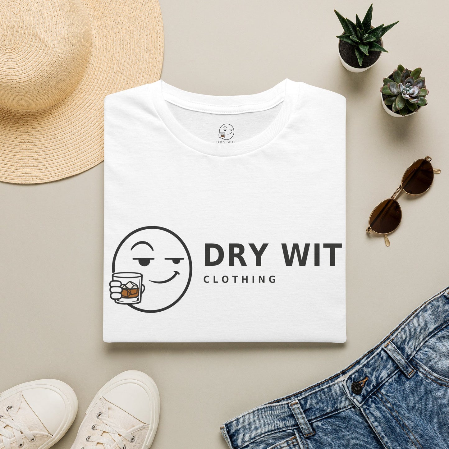 Dry Wit Logo Shirt, White, folded flat lay styled with a straw hat, sunglasses, sneakers and denim