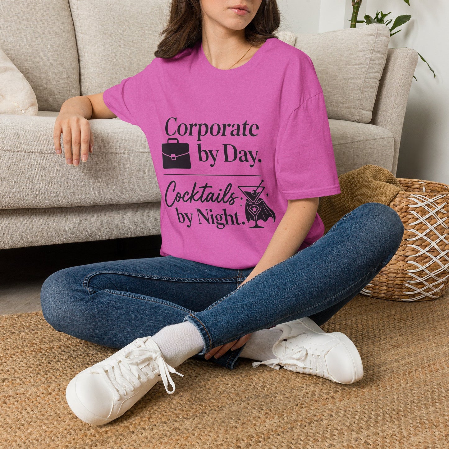 Corporate by Day, Cocktails by Night Shirt, Heather Berry pink, worn by a model seated on the floor beside a sofa
