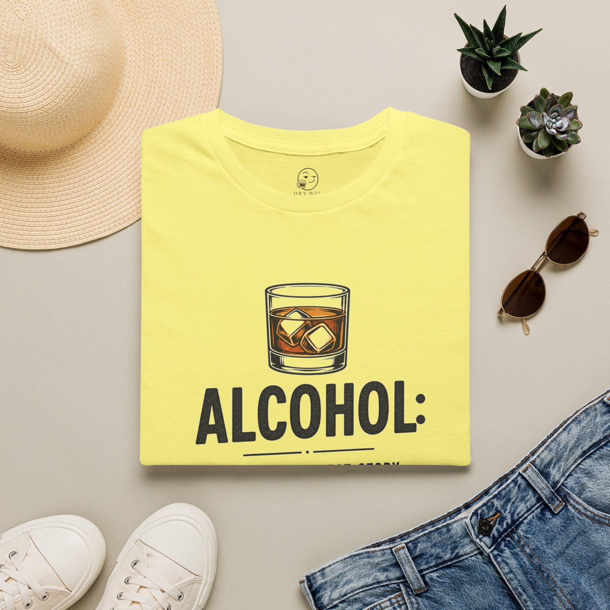 No Great Story Started With a Salad Shirt, Cornsilk pale yellow, folded flat lay styled with a straw hat, sunglasses, sneakers and denim
