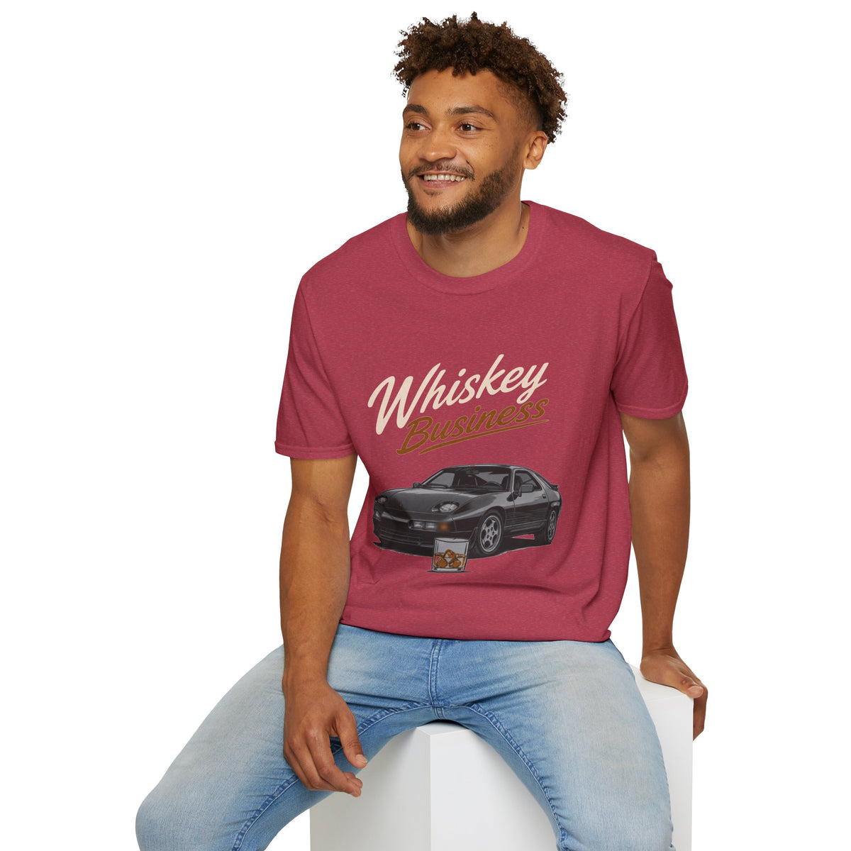 Whiskey Business Shirt, Heather Cardinal red, worn by a model seated on a white block