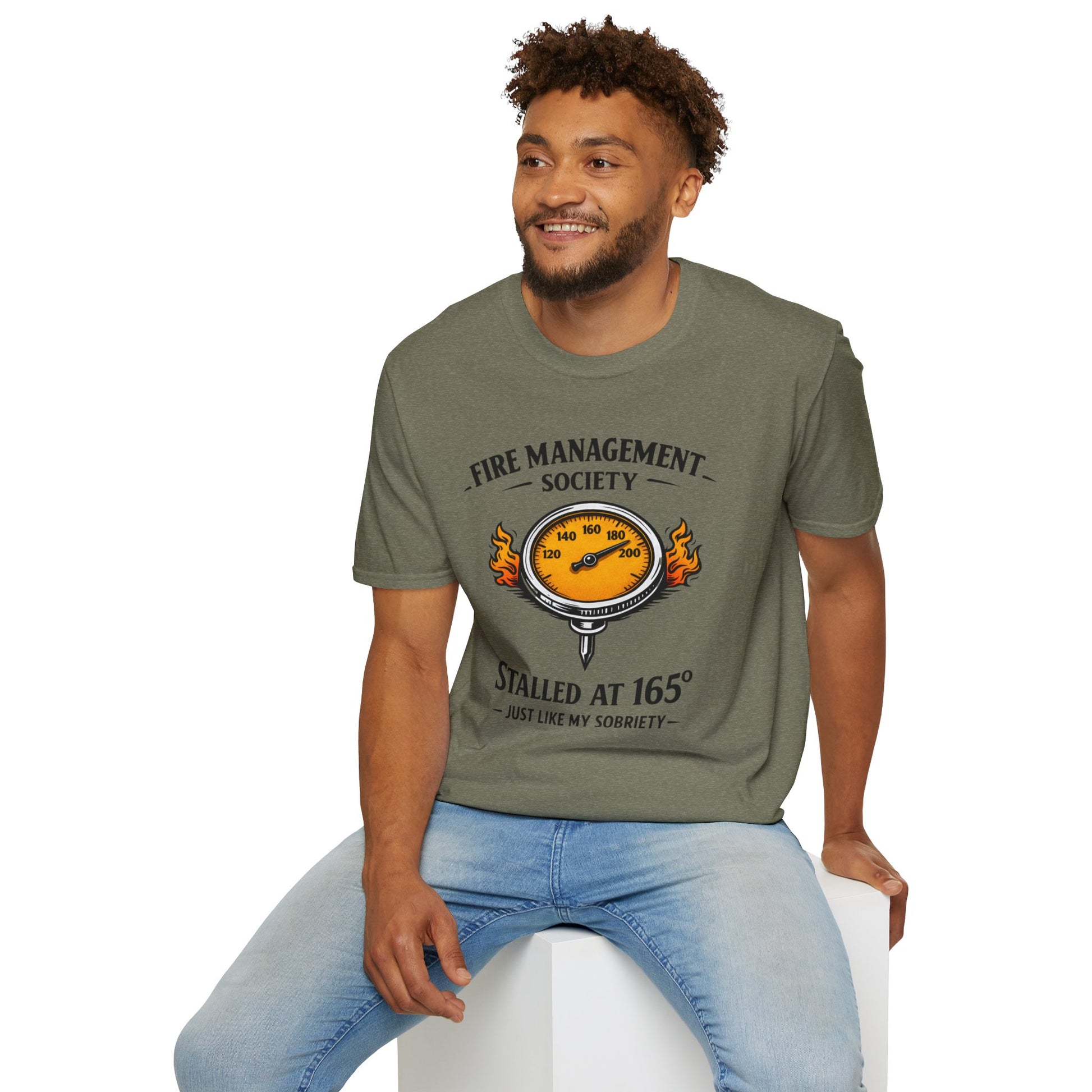 Fire Management Society Shirt, Heather Military Green olive, worn by a model seated on a white block