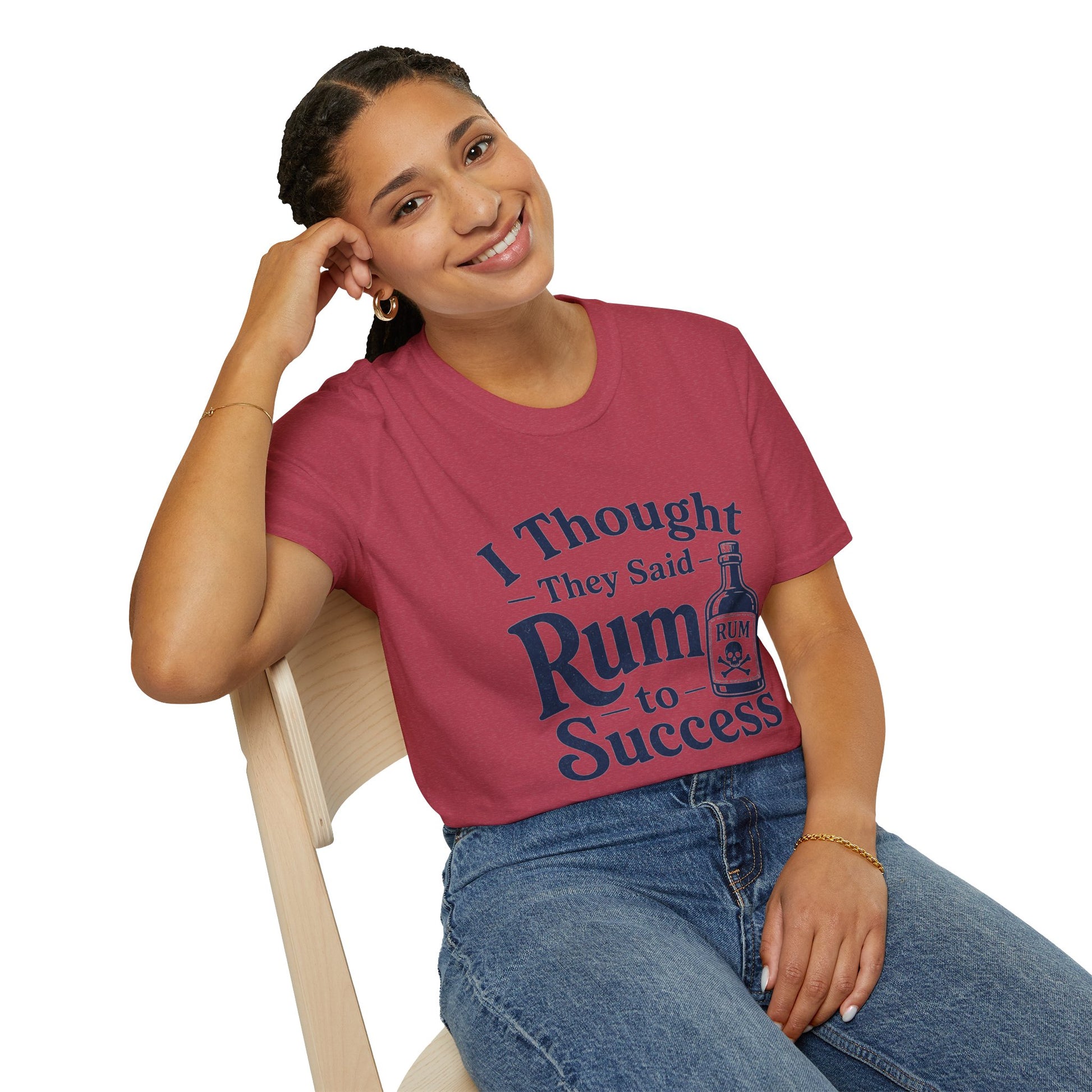 I Thought They Said Rum to Success Shirt, Heather Cardinal red, worn by a model seated on a wooden chair