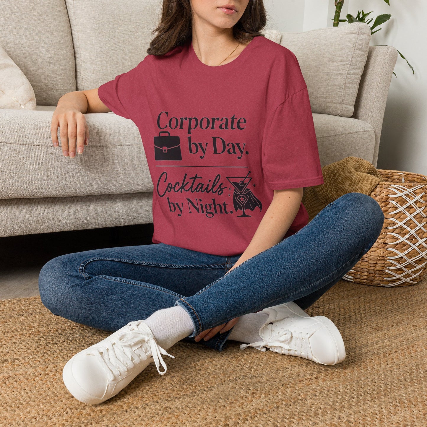Corporate by Day, Cocktails by Night Shirt, Heather Cardinal red, worn by a model seated on the floor beside a sofa