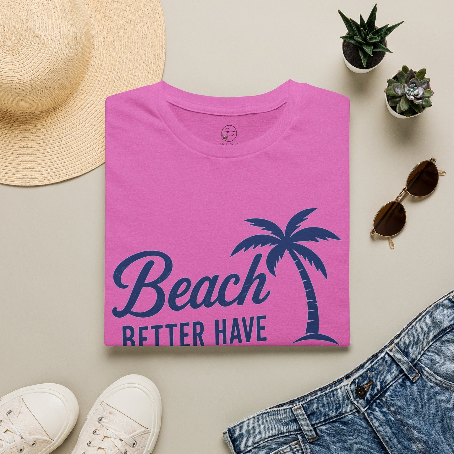 Beach Better Have My Cocktail Shirt, Heather Berry pink, folded flat lay styled with a straw hat, sunglasses, sneakers and denim