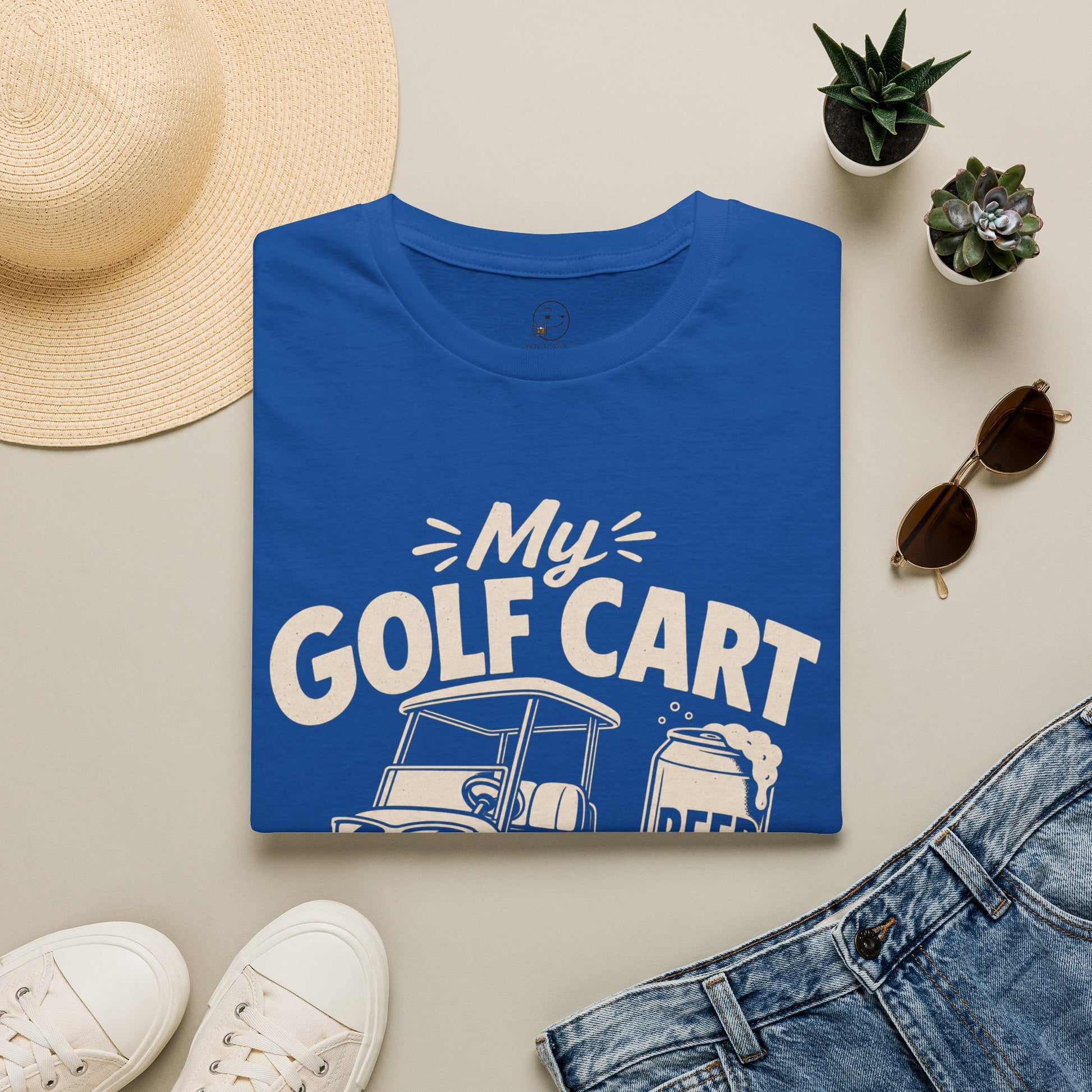 My Golf Cart Runs on Beer Shirt, Royal, folded flat lay styled with a straw hat, sunglasses, sneakers and denim