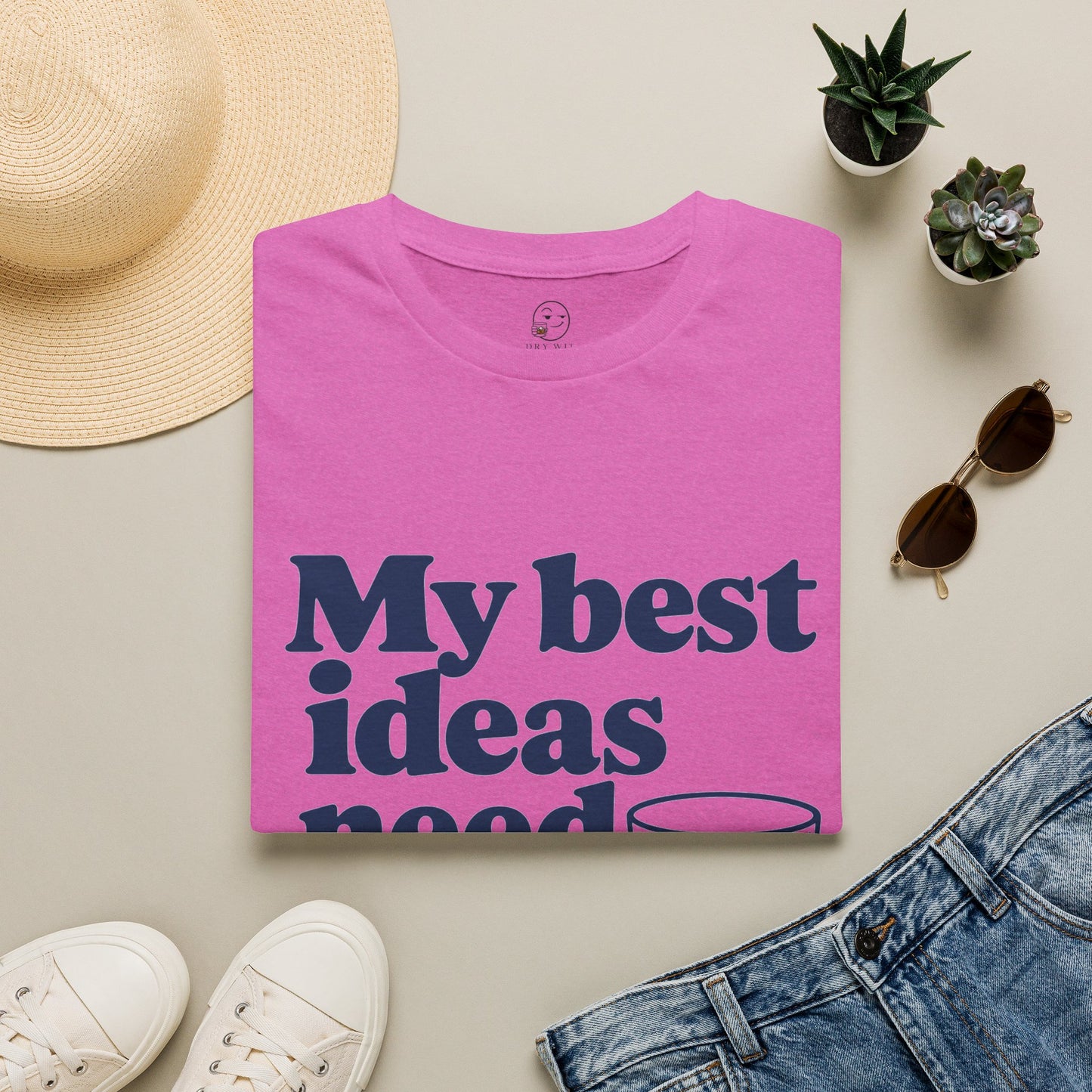 My Best Ideas Need Ice Shirt, Heather Berry pink, folded flat lay styled with a straw hat, sunglasses, sneakers and denim