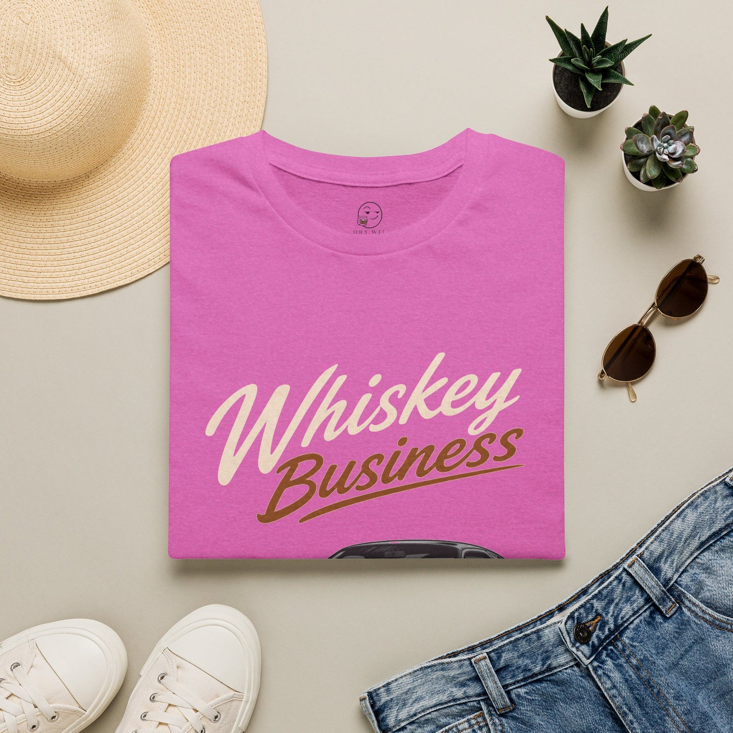 Whiskey Business Shirt, Heather Berry pink, folded flat lay styled with a straw hat, sunglasses, sneakers and denim