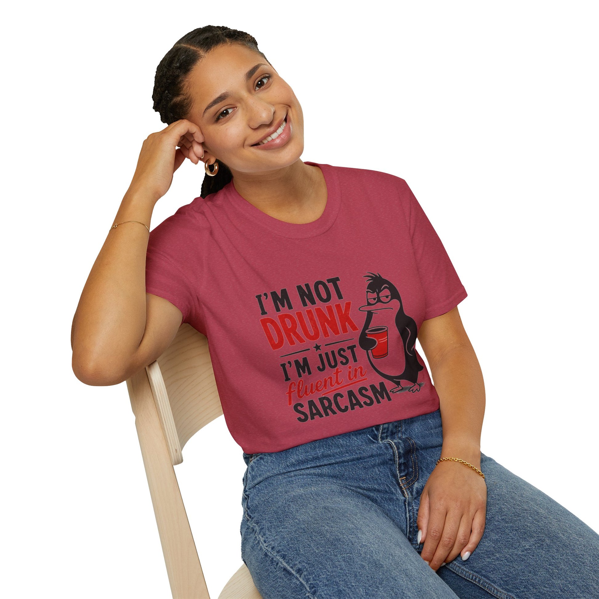 I'm Not Drunk, I'm Just Fluent in Sarcasm Shirt, Heather Cardinal red, worn by a model seated on a wooden chair