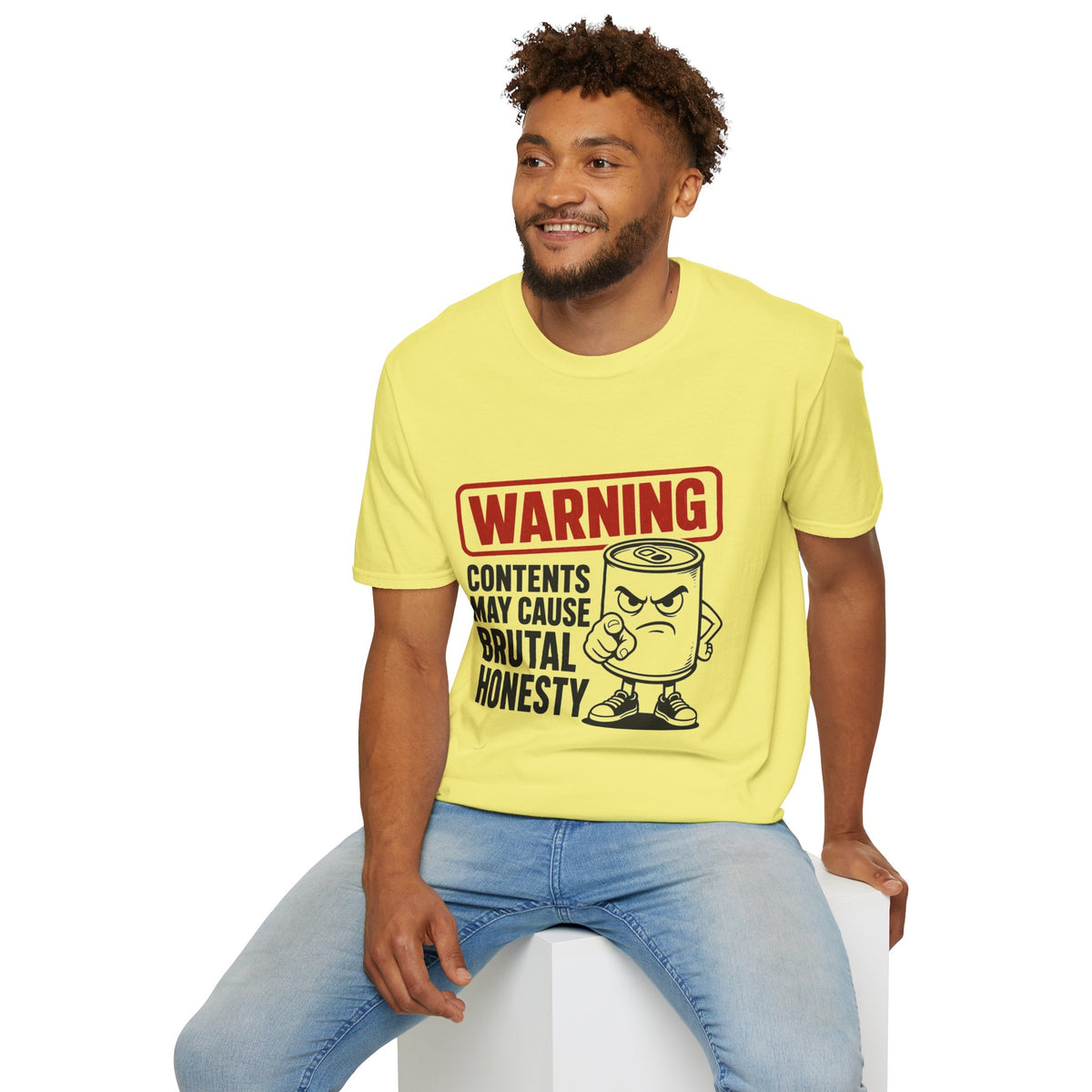 Warning: Contents May Cause Brutal Honesty Shirt, Cornsilk pale yellow, worn by a model seated on a white block